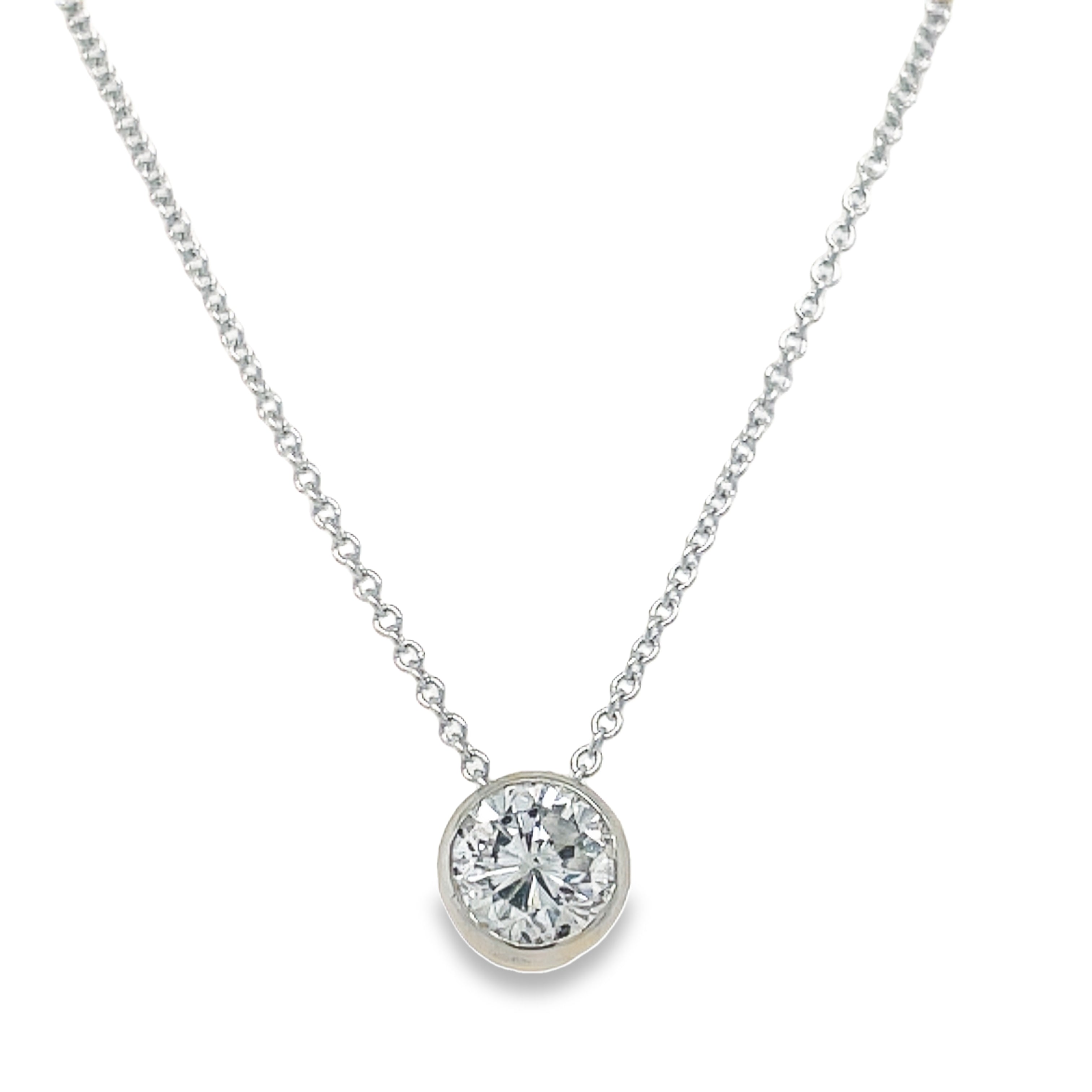 Indulge in luxury with our Round Diamond Solitaire Pendant Necklace. Crafted from 14k white gold, this necklace showcases a stunning round diamond weighing 0.89 cts. With a color grade of H/I and clarity of SI2, this piece radiates elegance and sophistication. The 18' length adds versatility, making it perfect for any occasion. Elevate your style with this exquisite necklace