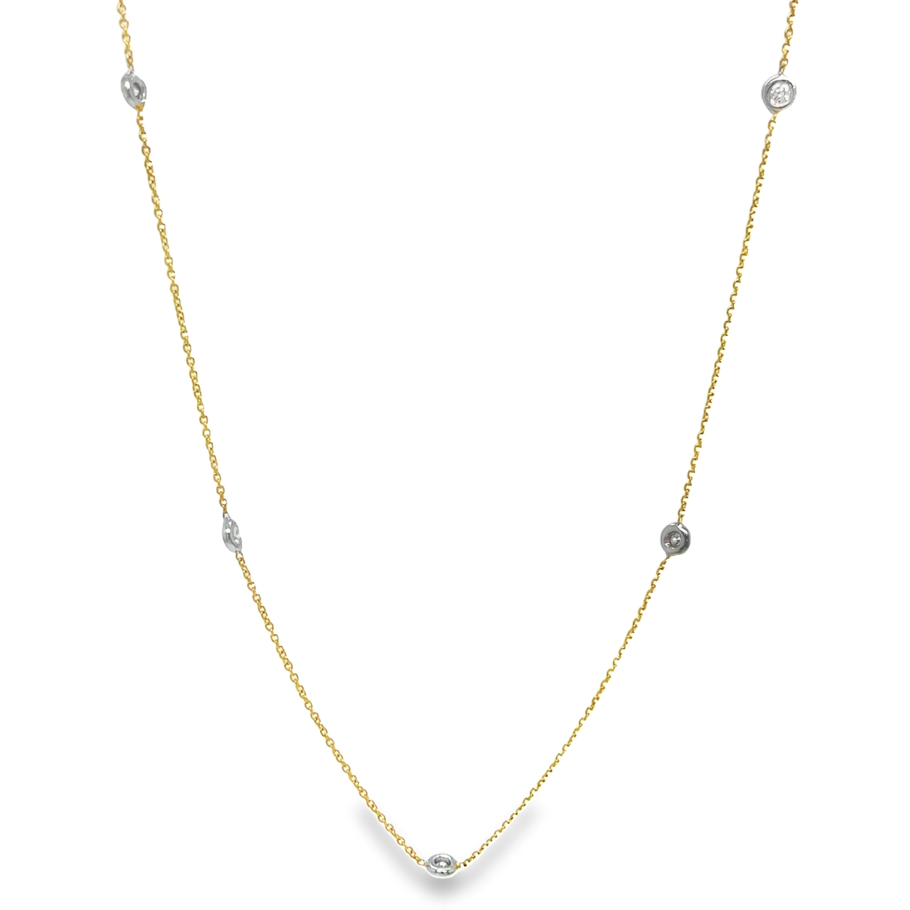 Experience timeless elegance with our Diamond by the Yard Necklace. Adorned with a dazzling round diamond totaling 0.15 carats, this necklace is securely bezel set in 18k white &amp; yellow gold. The 18-inch-long chain features a secure catch, ensuring it stays in place all day. Add a touch of sophistication to any outfit.