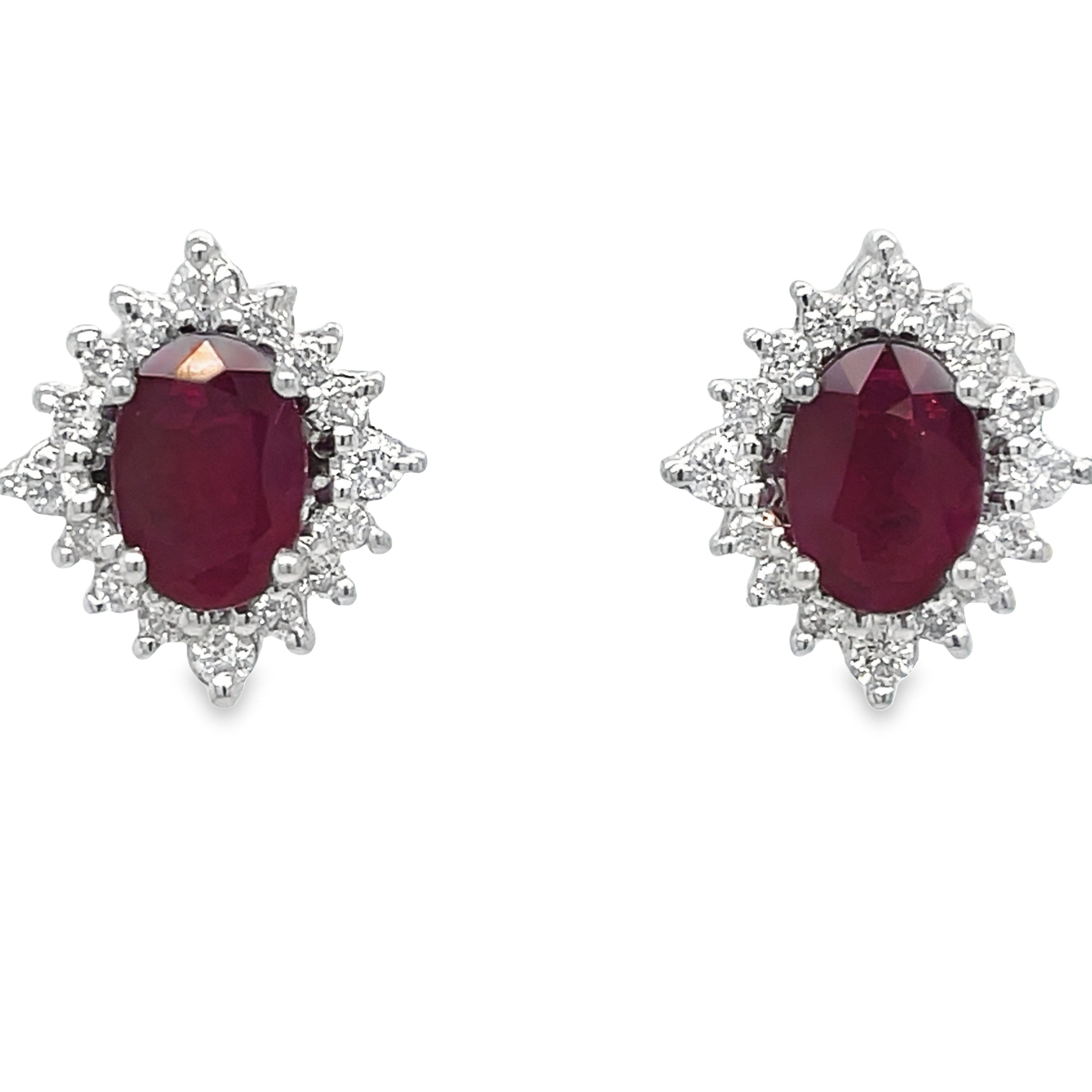 These elegant earrings feature oval-shaped rubies and round diamonds, set in 18k white gold. Measuring 12.00 x 10.00 mm, they make a stunning addition to any jewelry collection. The rubies add a touch of color while the diamonds bring a brilliant sparkle, making these earrings perfect for any occasion.
