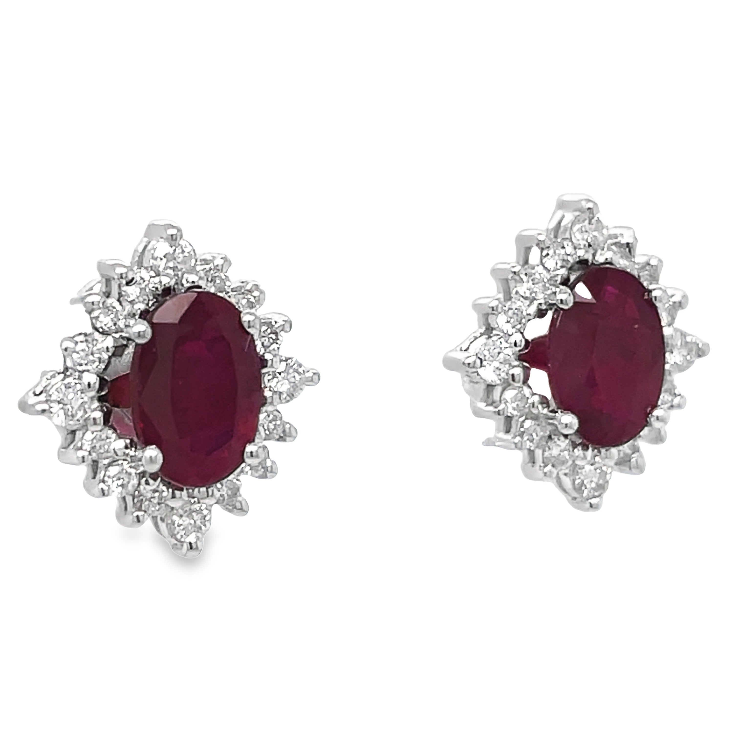 These elegant earrings feature oval-shaped rubies and round diamonds, set in 18k white gold. Measuring 12.00 x 10.00 mm, they make a stunning addition to any jewelry collection. The rubies add a touch of color while the diamonds bring a brilliant sparkle, making these earrings perfect for any occasion.