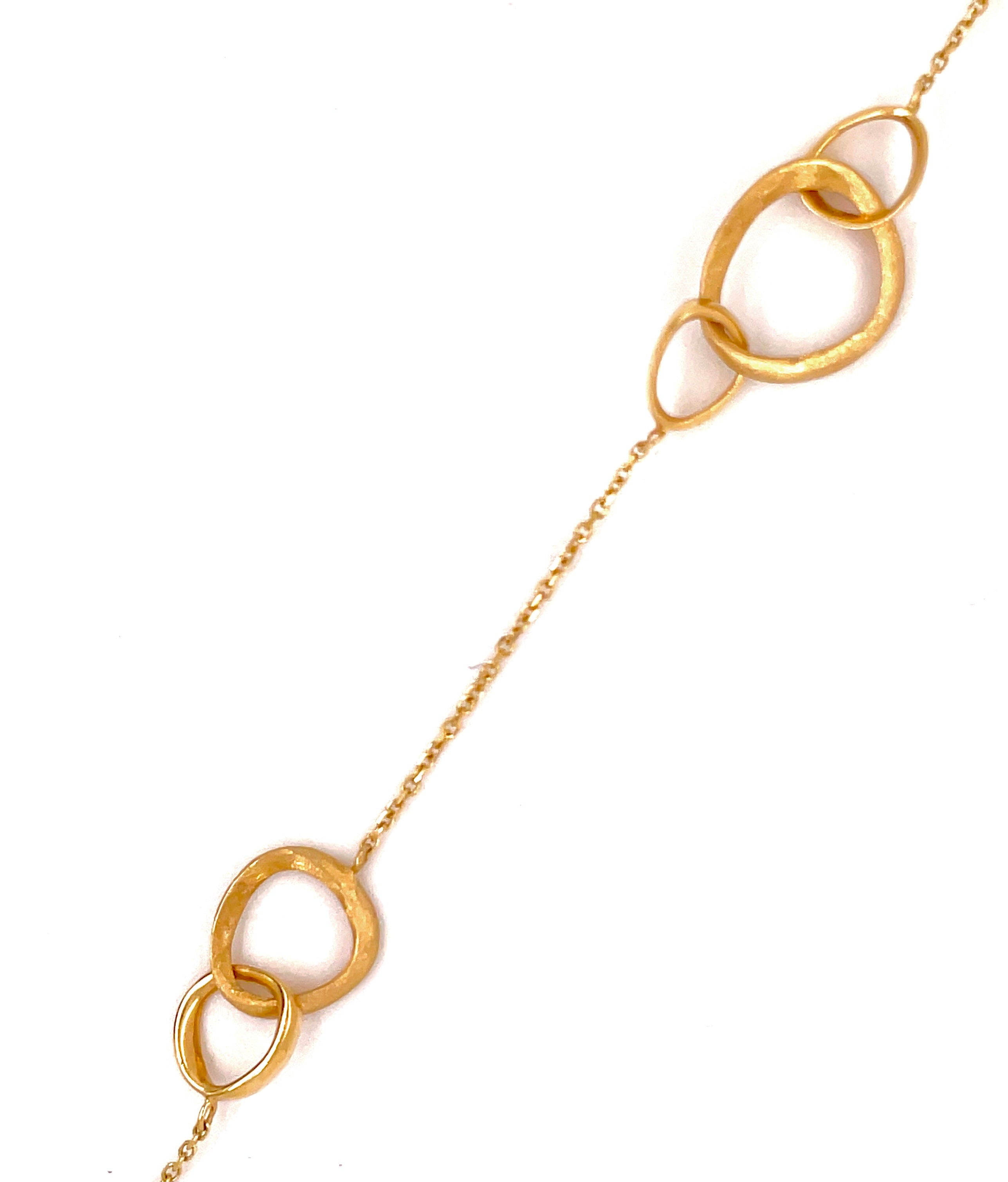 This 14k Yellow Gold Italian-made bracelet is 7" long, with the largest circle measuring 13.50. Its secure lobster catch ensures a safe closure, while its circle design adds a timeless aesthetic.