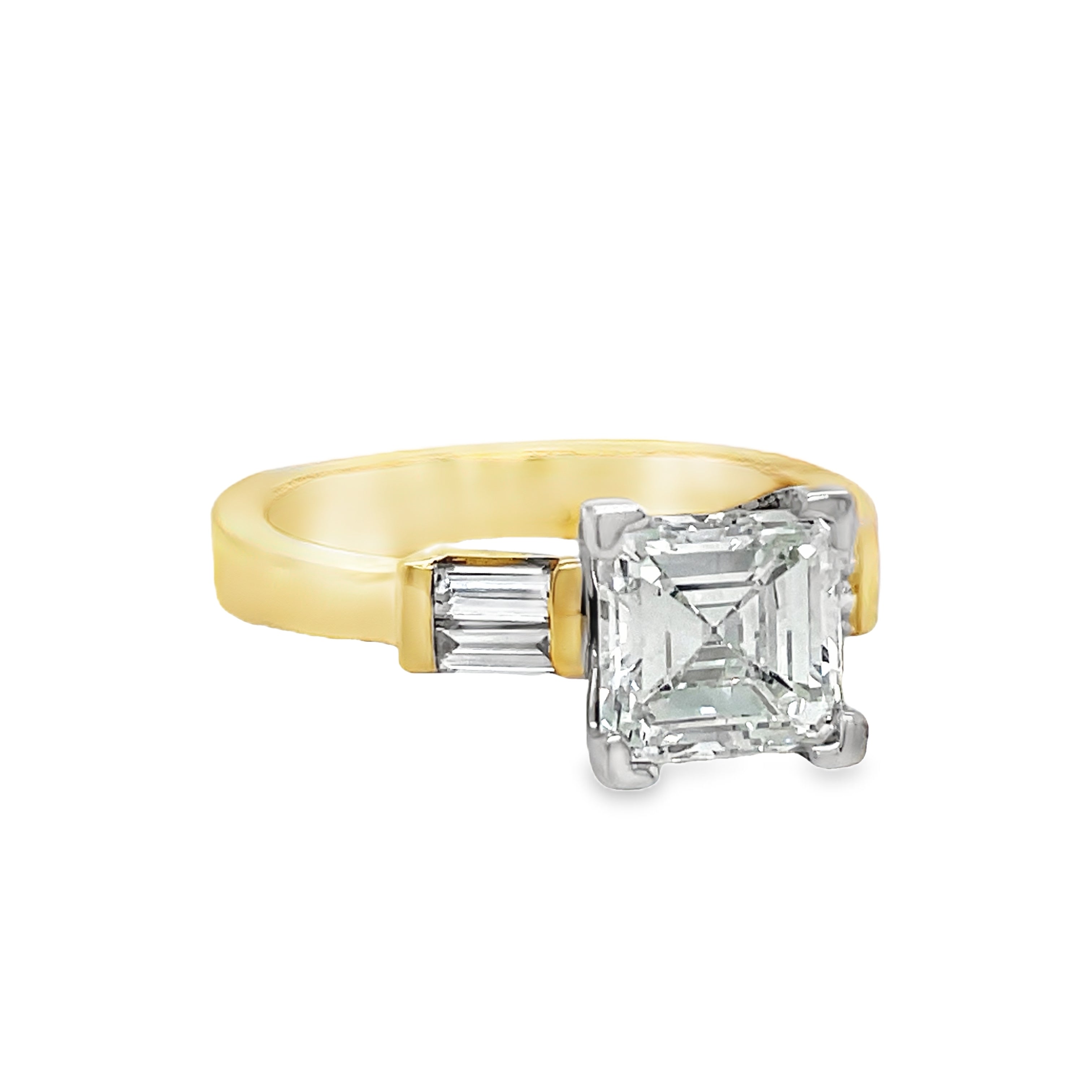 Indulge in the exquisite luxury of our Custom Made Assher Cut &amp; Baguette Engagement Ring, featuring a 14k yellow gold band adorned with a stunning 1.71 ct assher cut diamond in a prong setting. The color G and SI1 clarity ensure brilliance, while the delicate baguette diamonds on the side add a touch of sophistication. Elevate your proposal with this exclusive, one-of-a-kind ring.