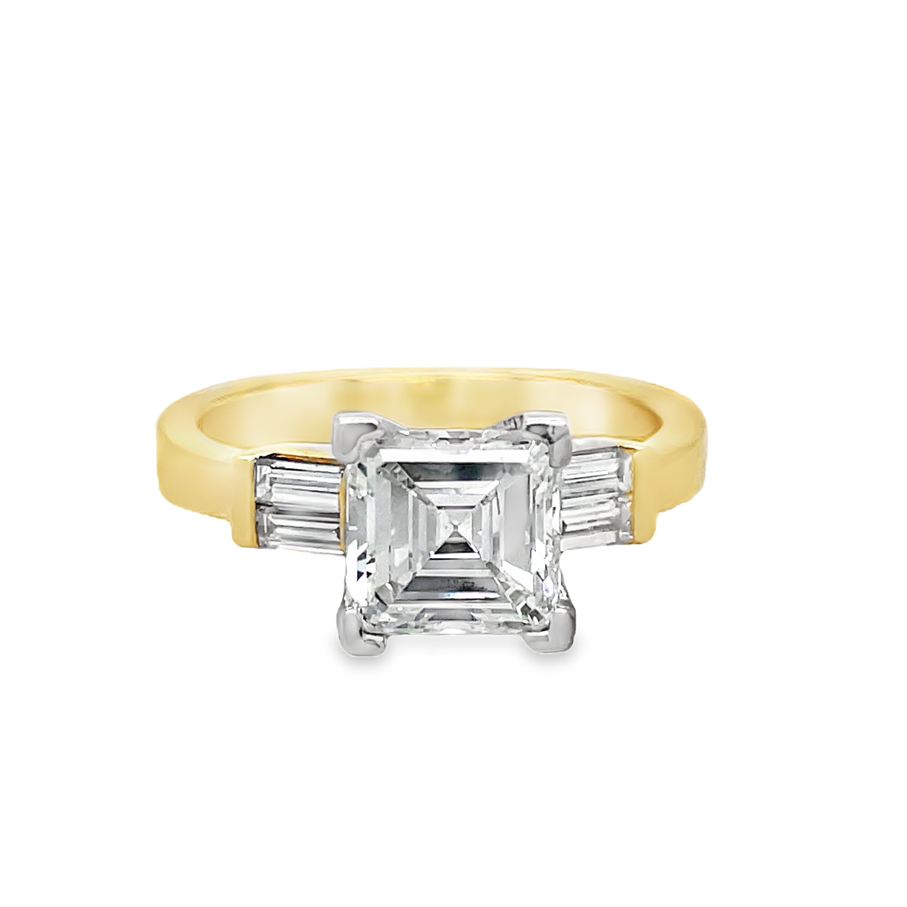 Indulge in the exquisite luxury of our Custom Made Assher Cut &amp; Baguette Engagement Ring, featuring a 14k yellow gold band adorned with a stunning 1.71 ct assher cut diamond in a prong setting. The color G and SI1 clarity ensure brilliance, while the delicate baguette diamonds on the side add a touch of sophistication. Elevate your proposal with this exclusive, one-of-a-kind ring.