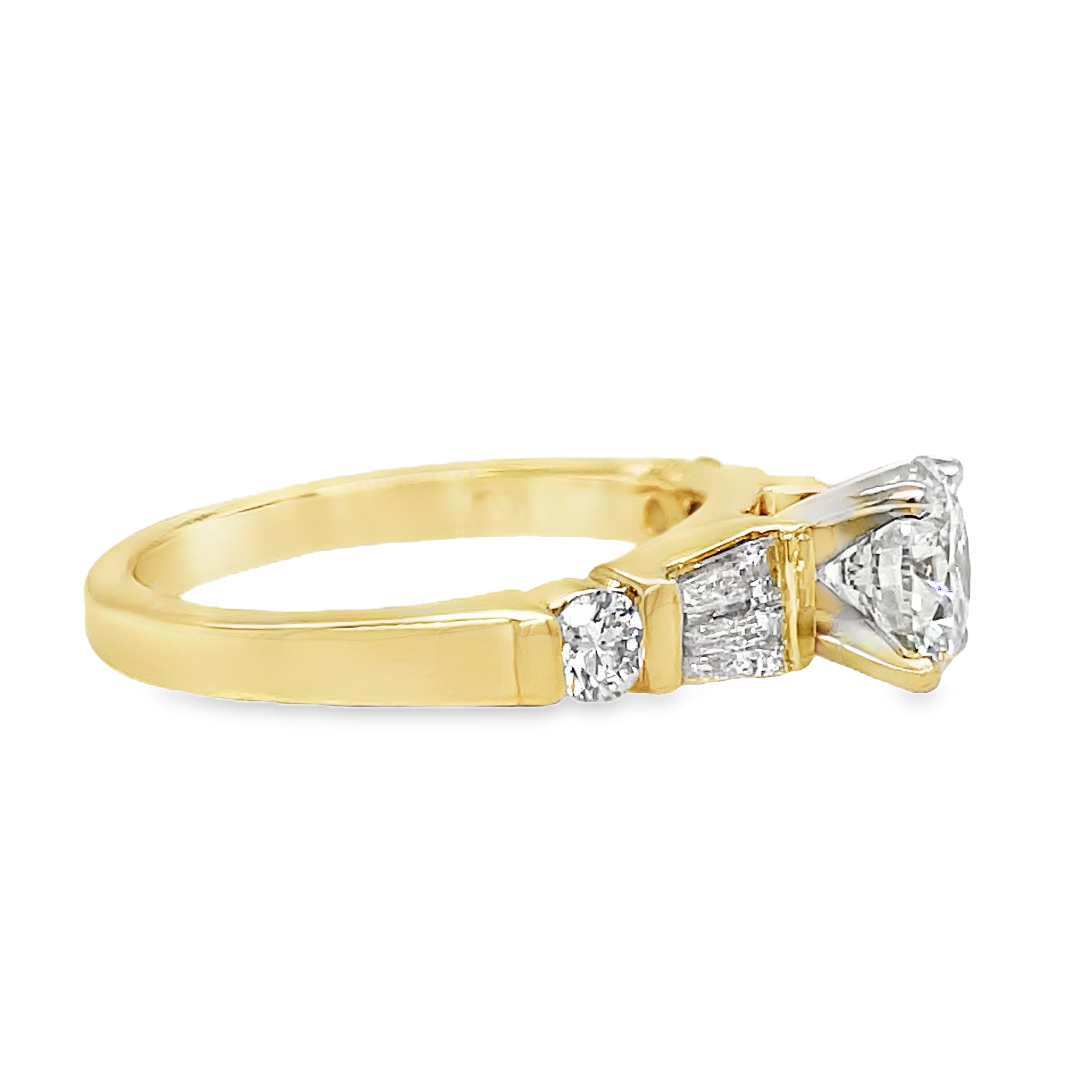 ndulge in luxury with this Round Brilliant Diamond &amp; Baguette Engagement Ring. With a striking 1.02 ct round brilliant diamond, framed by tapered baguette diamonds and two small round diamonds totaling 0.40 cts, this exquisite ring exudes elegance and sophistication. Crafted in 14k yellow gold, it's the perfect symbol of your love.