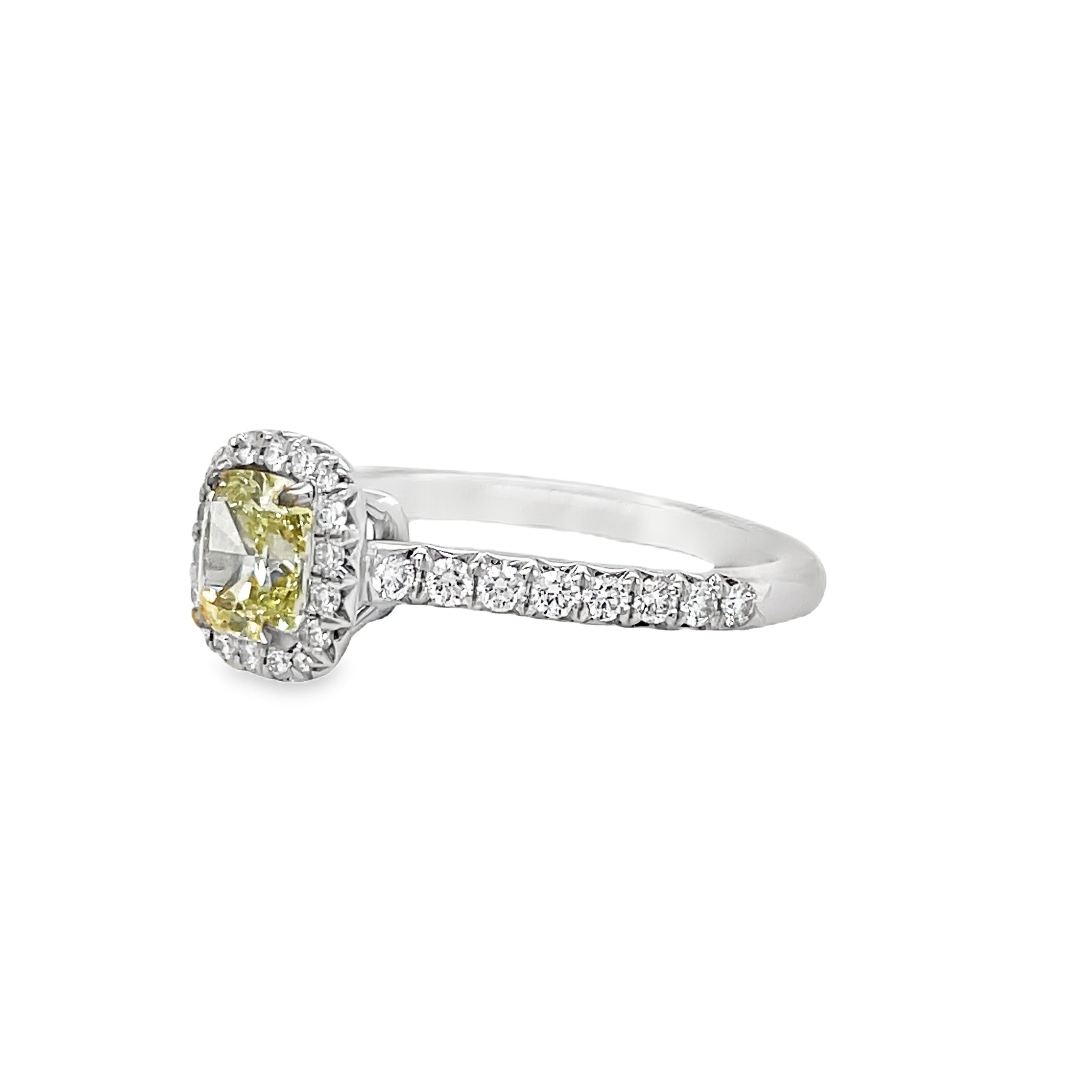 ntroducing our exquisite Estate Tiffany and Co. Fancy Yellow Diamond and Round Diamond Engagement Ring. Crafted with platinum and boasting a stunning 0.72 ct fancy yellow diamond with VS1 clarity, this ring exudes elegance and sophistication. Surrounded by 0.70 cts of sparkling round diamonds, it is a true masterpiece that will captivate any admirer. Elevate your love with this luxurious and exclusive piece.