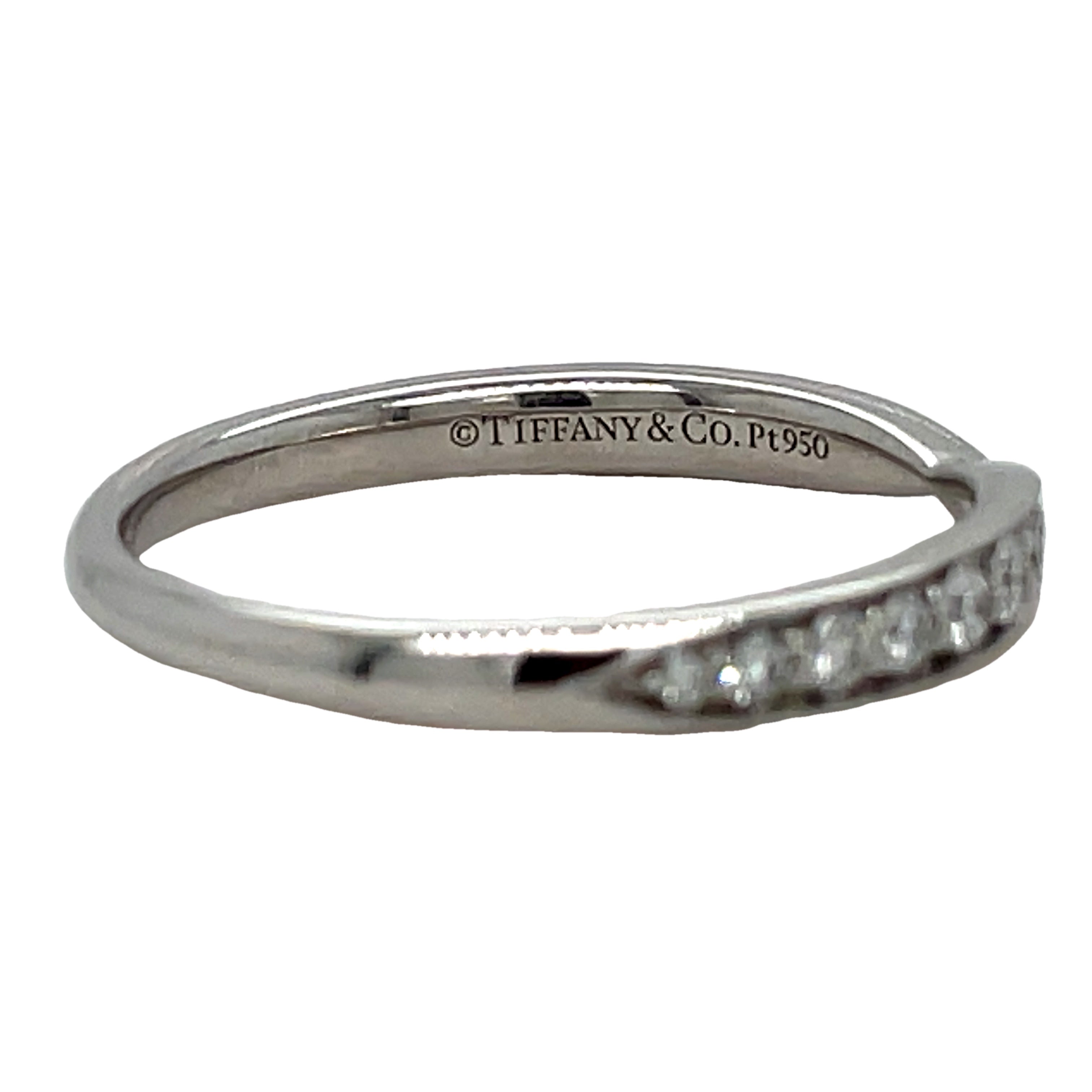 This stunning Estate Tiffany and Co. Diamond Wedding Band features a unique v-shape design adorned with brilliant round diamonds. Crafted from luxurious platinum, this band is an elegant and exclusive choice for your special day. Add a touch of sophistication and luxury to your wedding ensemble with this one-of-a-kind piece from Tiffany and Co.