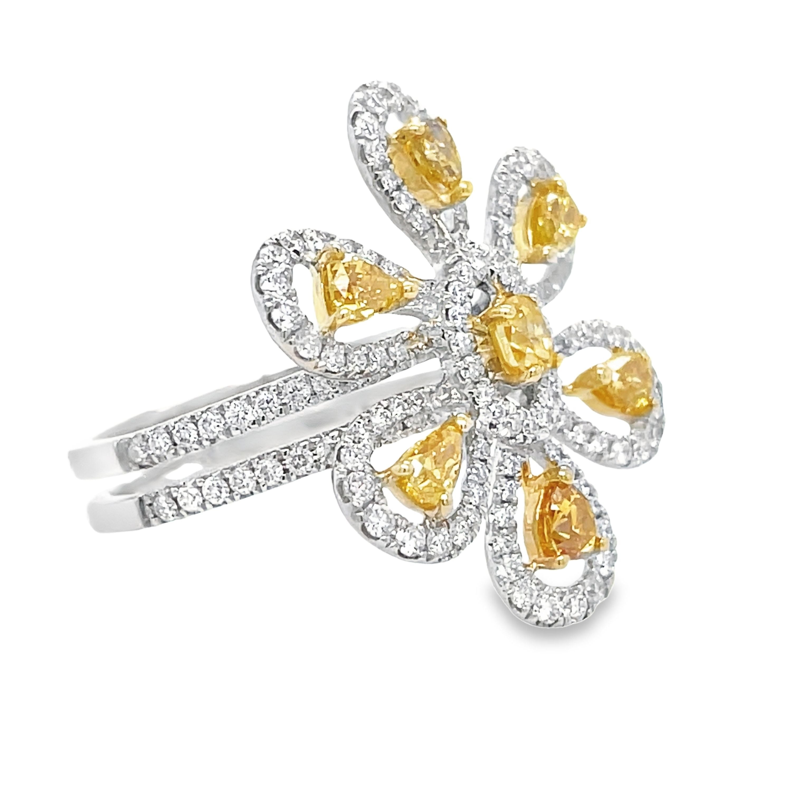 This exquisite cocktail ring features a stunning one-of-a-kind design, with a large diamond flower centerpiece surrounded by high-quality yellow diamonds 0.89 cts and round diamonds 0.82 cts. Crafted from 18k white gold, its double shank adds elegance and sparkle. Measuring 24.50 mm in width, this size 7 (sizeable) ring is a true statement piece.