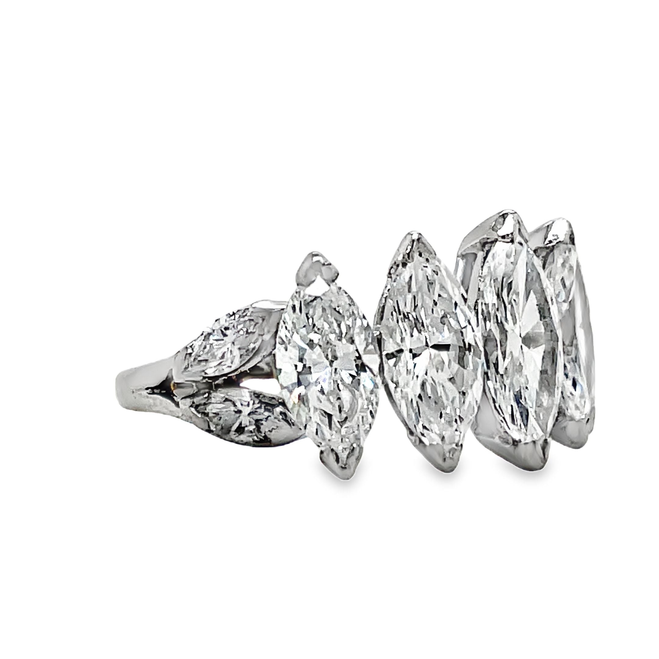 Indulge in luxury with our Platinum Marquise Cut Anniversary Ring. Five large, graduated marquise cut diamonds totaling 5.10 carats elegantly adorn this platinum ring. With a color grade of G/H and clarity of VVS1, this ring is a true masterpiece, perfect for celebrating your special milestones.