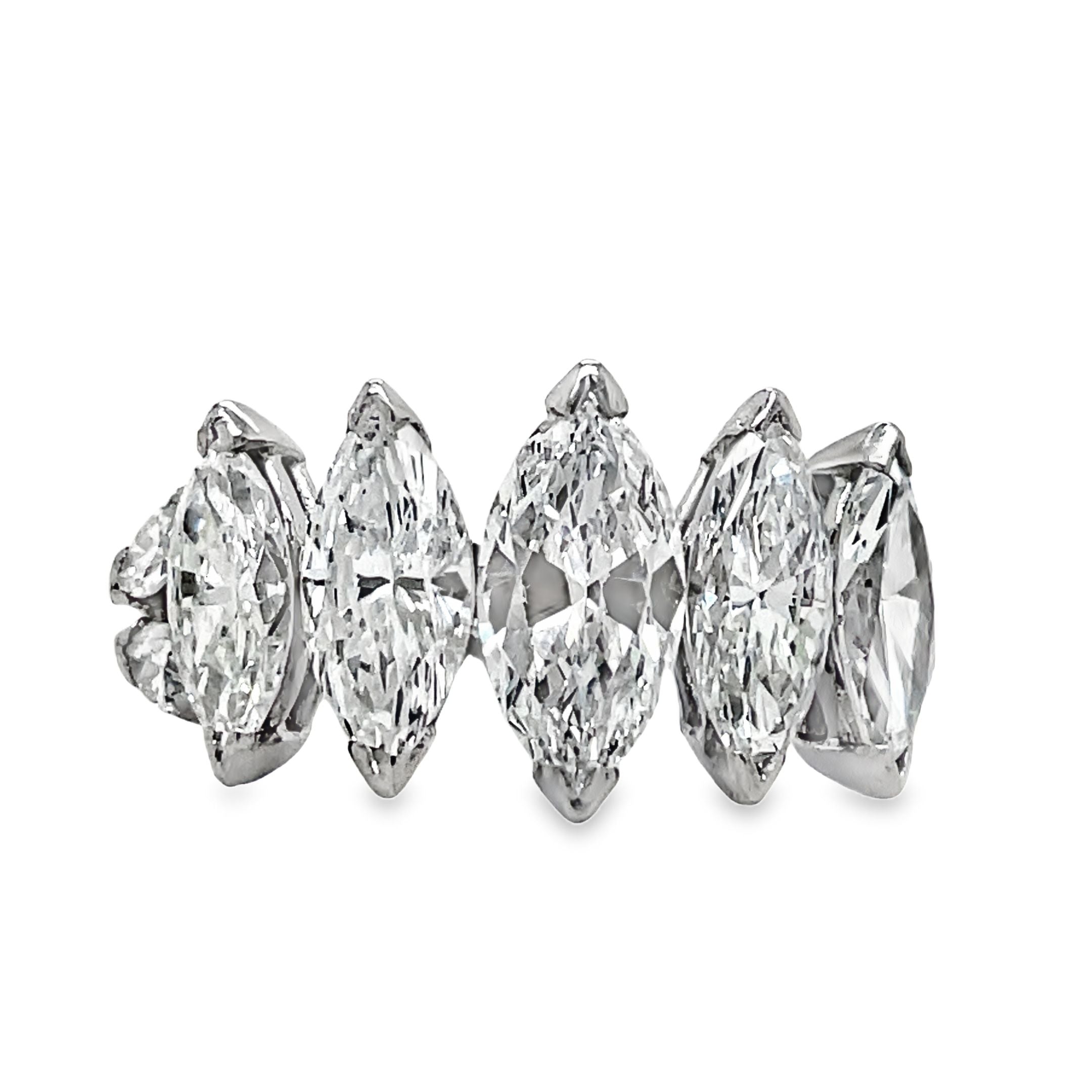 Indulge in luxury with our Platinum Marquise Cut Anniversary Ring. Five large, graduated marquise cut diamonds totaling 5.10 carats elegantly adorn this platinum ring. With a color grade of G/H and clarity of VVS1, this ring is a true masterpiece, perfect for celebrating your special milestones.