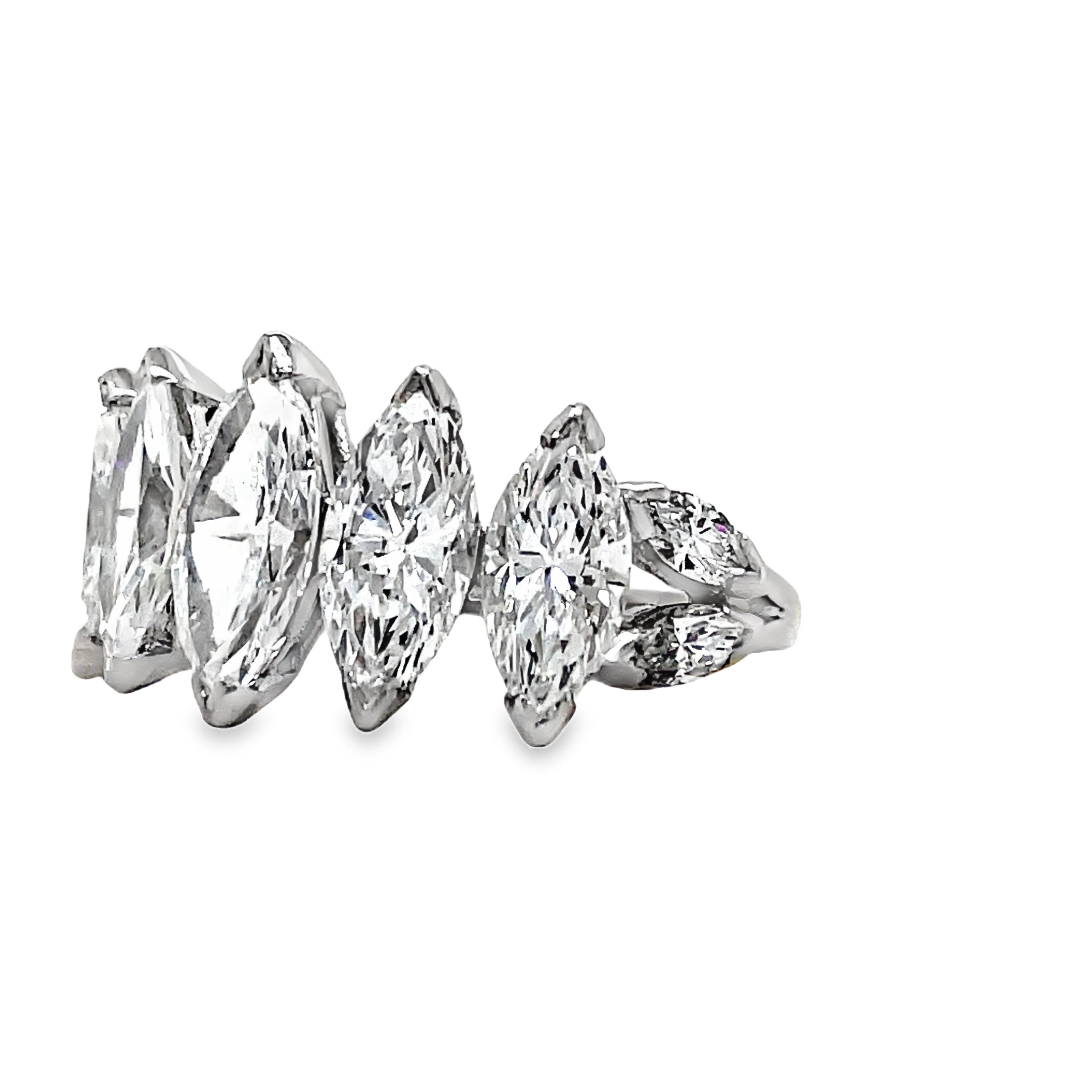 Indulge in luxury with our Platinum Marquise Cut Anniversary Ring. Five large, graduated marquise cut diamonds totaling 5.10 carats elegantly adorn this platinum ring. With a color grade of G/H and clarity of VVS1, this ring is a true masterpiece, perfect for celebrating your special milestones.