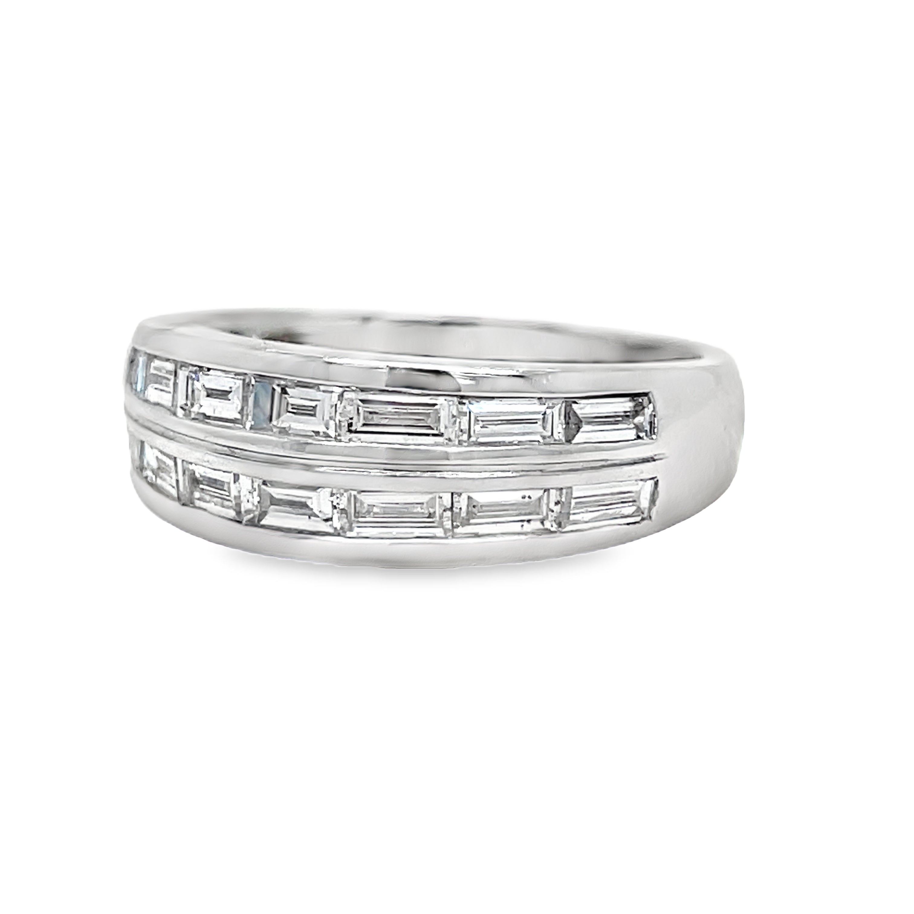 Indulge in luxury with our Anniversary Baguette Diamond Band. Featuring 1.00 cts of baguette and round diamonds in a double row, set in bright 18k white gold. With a striking dome style, this band exudes elegance and sophistication. Upgrade your collection today.