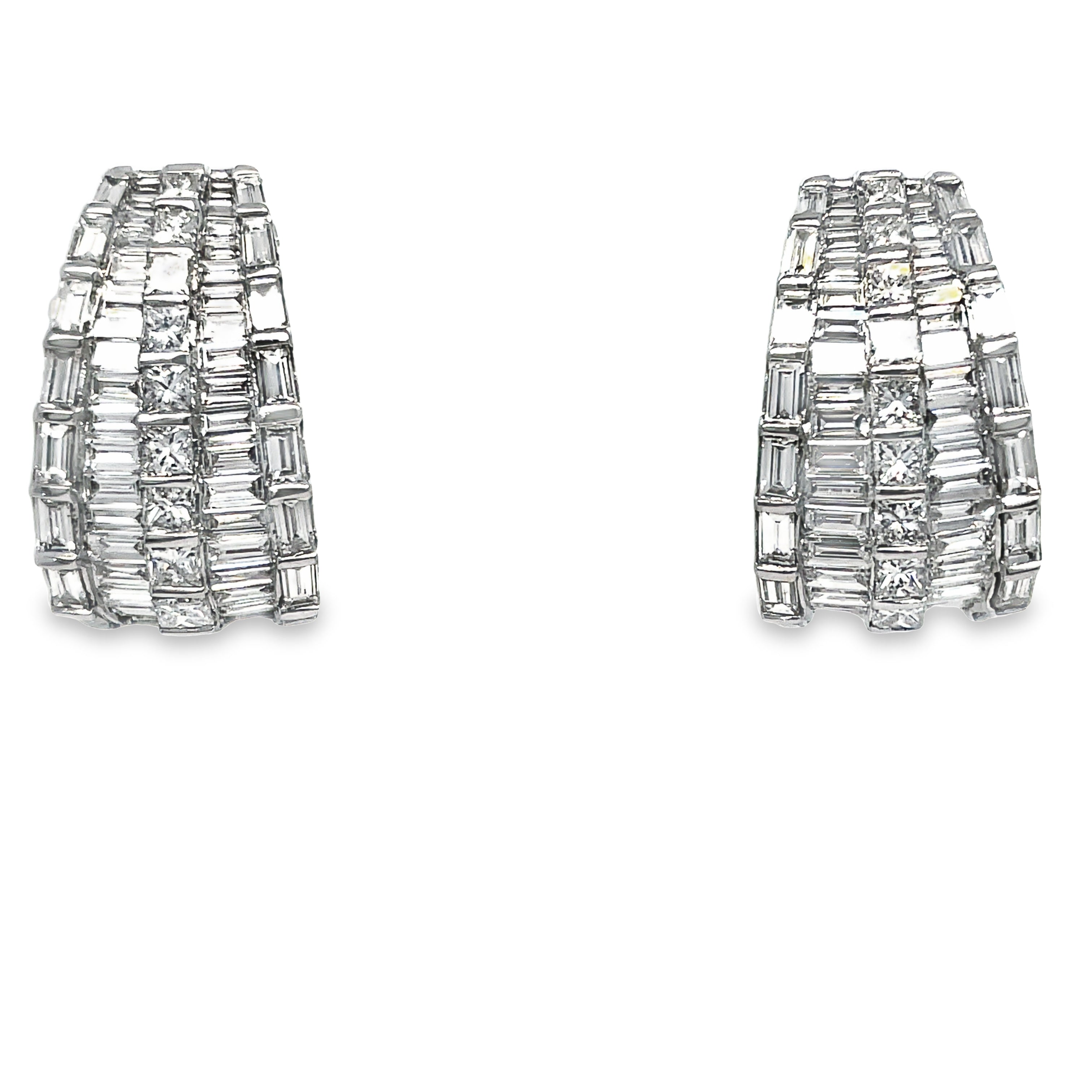 Expertly crafted in 18k white gold, these stunning drop earrings feature a mix of baguette and round diamonds totaling 6.47 cts. With a secure omega clip system, these high-quality diamonds will add elegance and sparkle to any outfit.