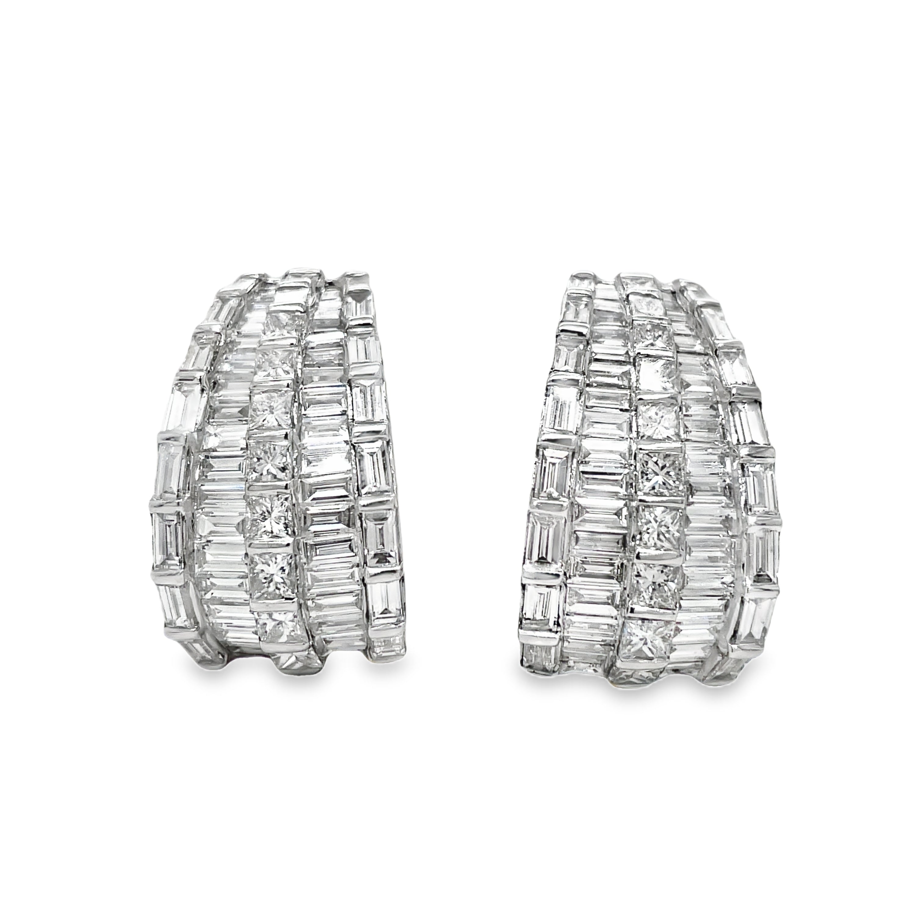 Expertly crafted in 18k white gold, these stunning drop earrings feature a mix of baguette and round diamonds totaling 6.47 cts. With a secure omega clip system, these high-quality diamonds will add elegance and sparkle to any outfit.