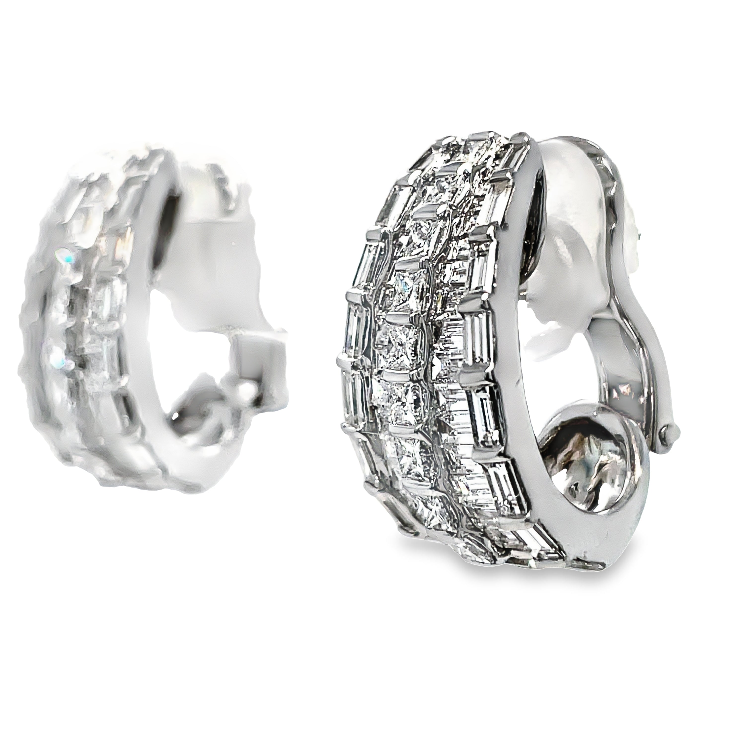 Expertly crafted in 18k white gold, these stunning drop earrings feature a mix of baguette and round diamonds totaling 6.47 cts. With a secure omega clip system, these high-quality diamonds will add elegance and sparkle to any outfit.