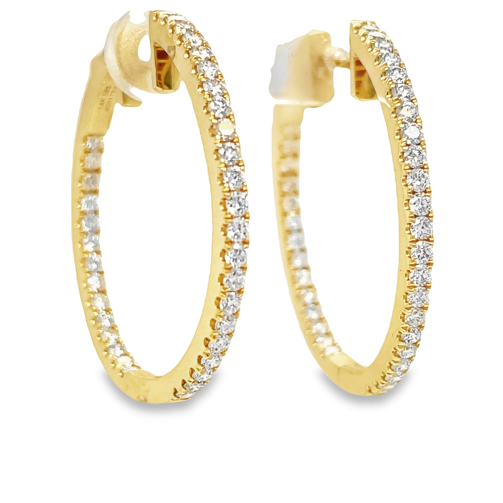 These medium hoop Earrings feature 1.54 ct round diamonds of F/G color and VS1 clarity. The hoops are 2.50 mm thick and 1.5" long, crafted from 14k yellow gold with a secure lock clasp. Lever back system ensures the earrings are easy to put on and take off.