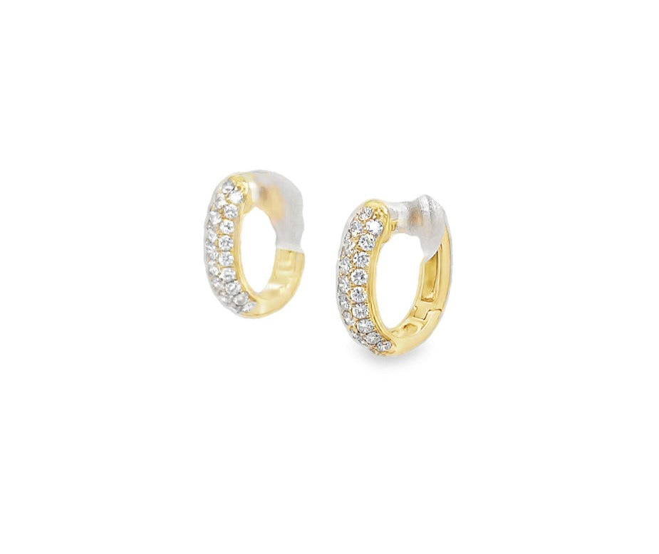 Elevate your style with our 18K Diamond Huggie Earrings. Crafted in 18k yellow gold, these earrings feature a stunning array of round pave diamonds, totaling 0.47 cts. The 13.00 mm size and hinged system make them easy to wear and the perfect addition to any outfit. Experience the luxury of sophisticated elegance with these earrings.