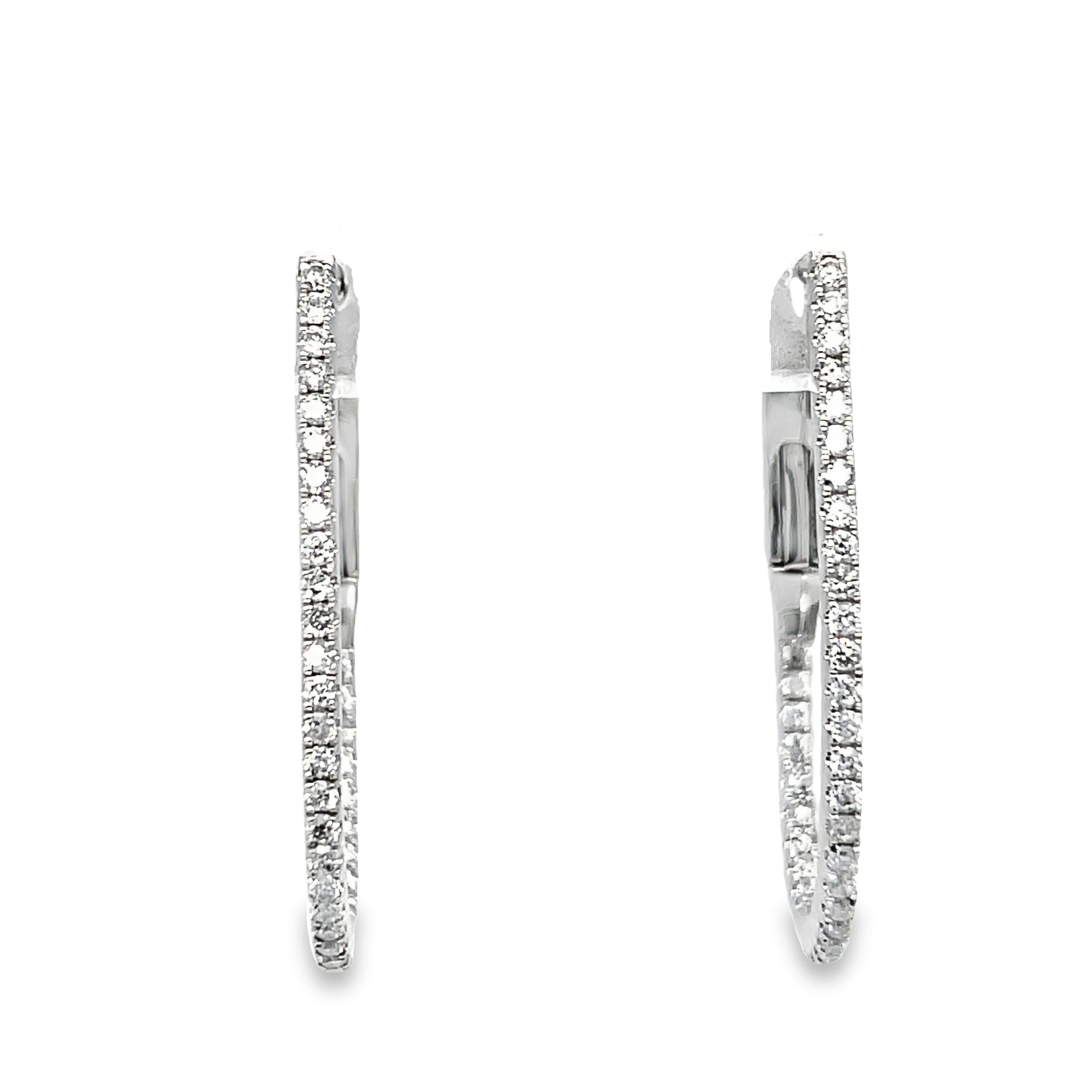 Crafted with 18k white gold, these oval-shaped diamond hoop earrings feature a secure hinged system. Adorned with round diamonds totaling 0.39 carats, these earrings add a touch of sparkle and elegance to any outfit. Trust in the expert design for a timeless and secure accessory. 1" size&nbsp;