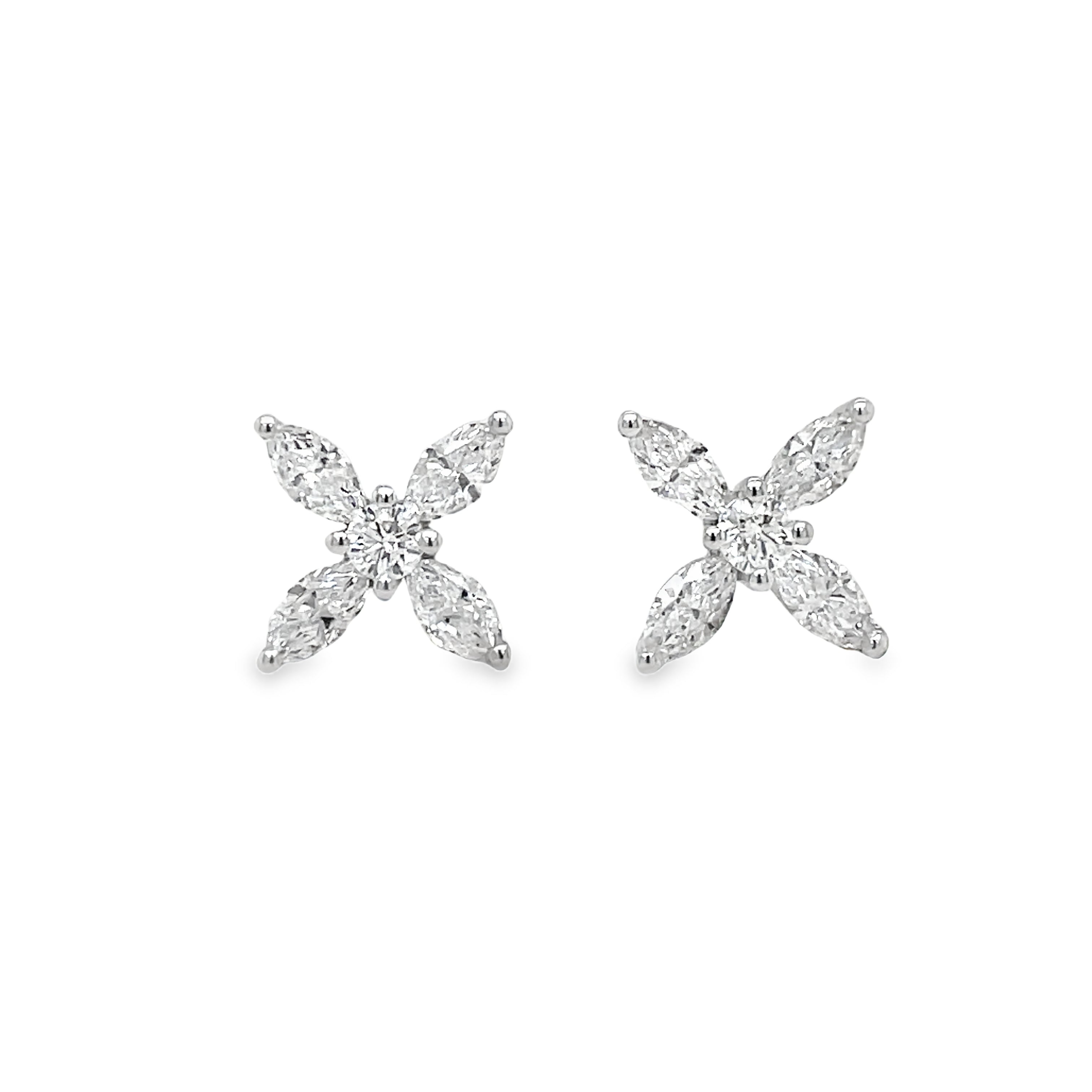 Elevate your style with our Four Marquise Diamond Stud Earrings. Eight dazzling, high-quality diamonds totaling 0.99 cts are set in 18k white gold. In F/G color and VS1 clarity, these studs are truly timeless. Complete with secure friction backs and measuring at 9.00mm wide, these earrings are a luxurious addition to any jewelry collection.