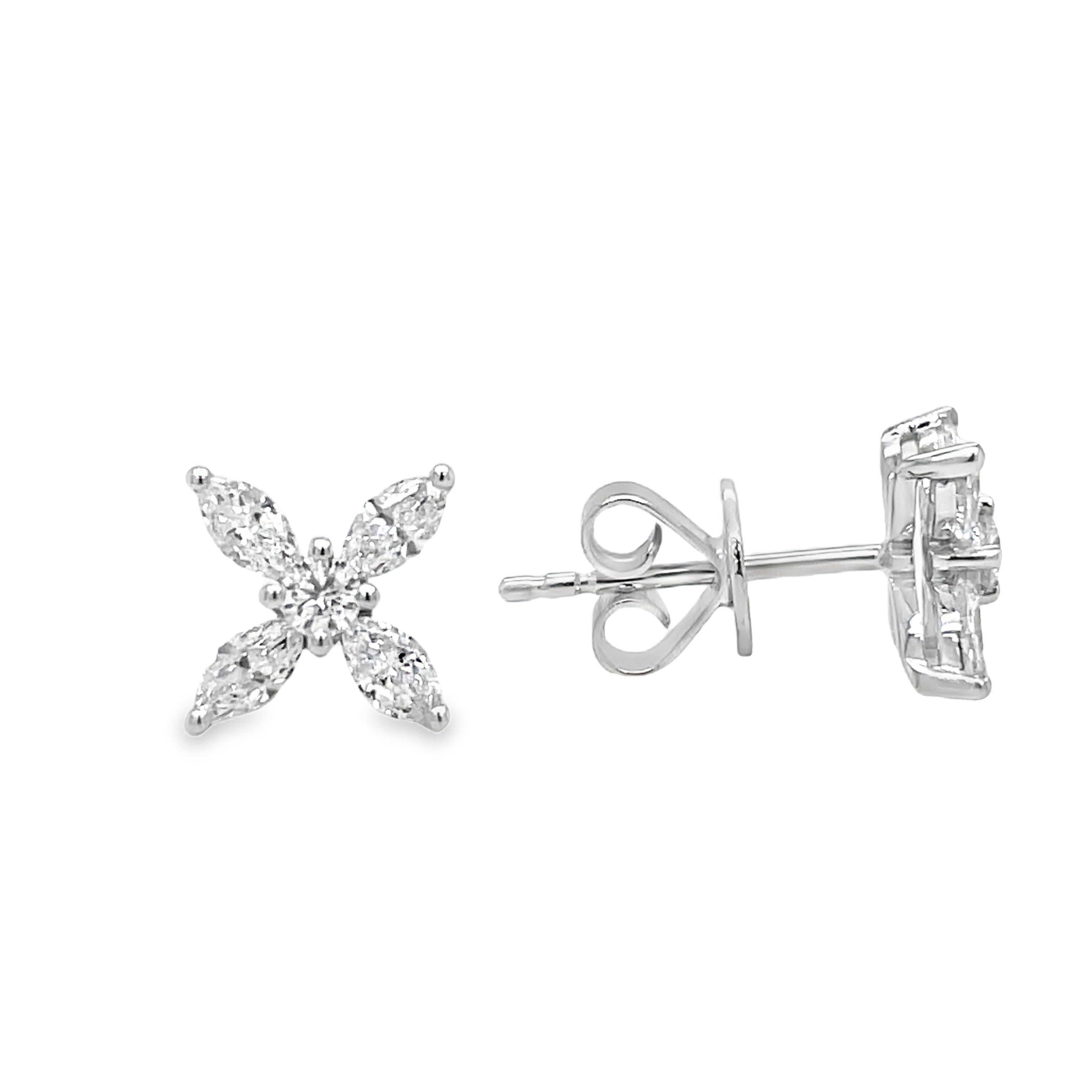 Elevate your style with our Four Marquise Diamond Stud Earrings. Eight dazzling, high-quality diamonds totaling 0.99 cts are set in 18k white gold. In F/G color and VS1 clarity, these studs are truly timeless. Complete with secure friction backs and measuring at 9.00mm wide, these earrings are a luxurious addition to any jewelry collection.