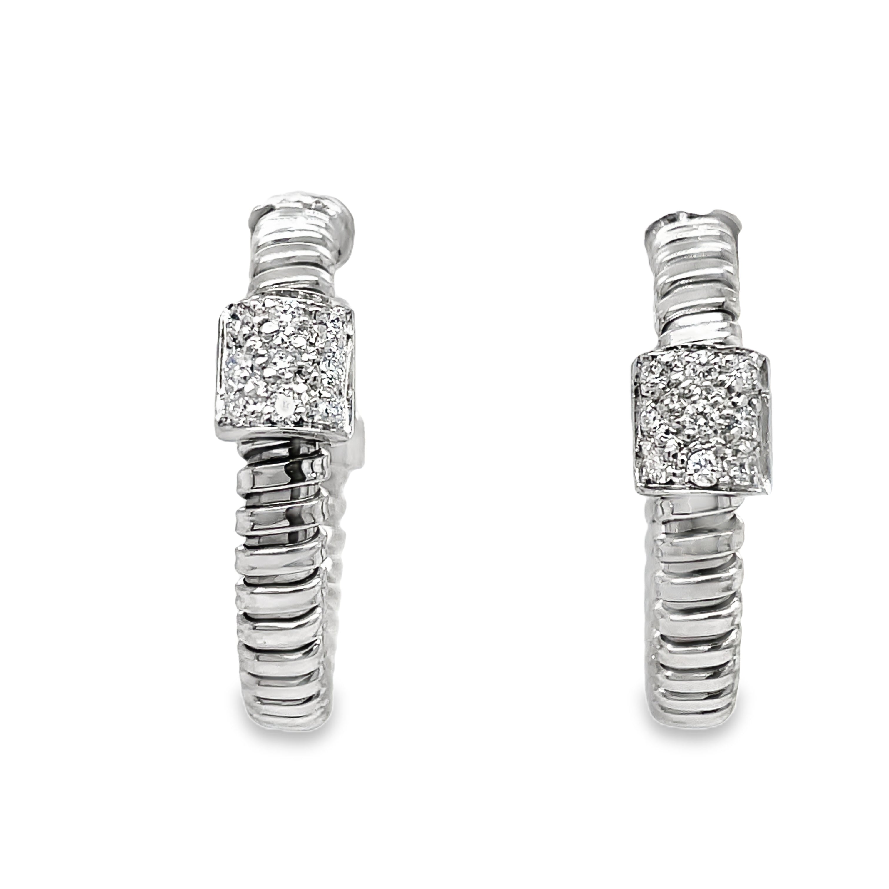 Indulge in luxury with our Italian made,18K white gold hoop earrings. Meticulously crafted by Novecentonovantanove, these exquisite earrings feature 0.18 carats of round diamonds and secure friction backs for added convenience. Elevate your style with this elegant and exclusive accessory. 3/4 " size&nbsp;