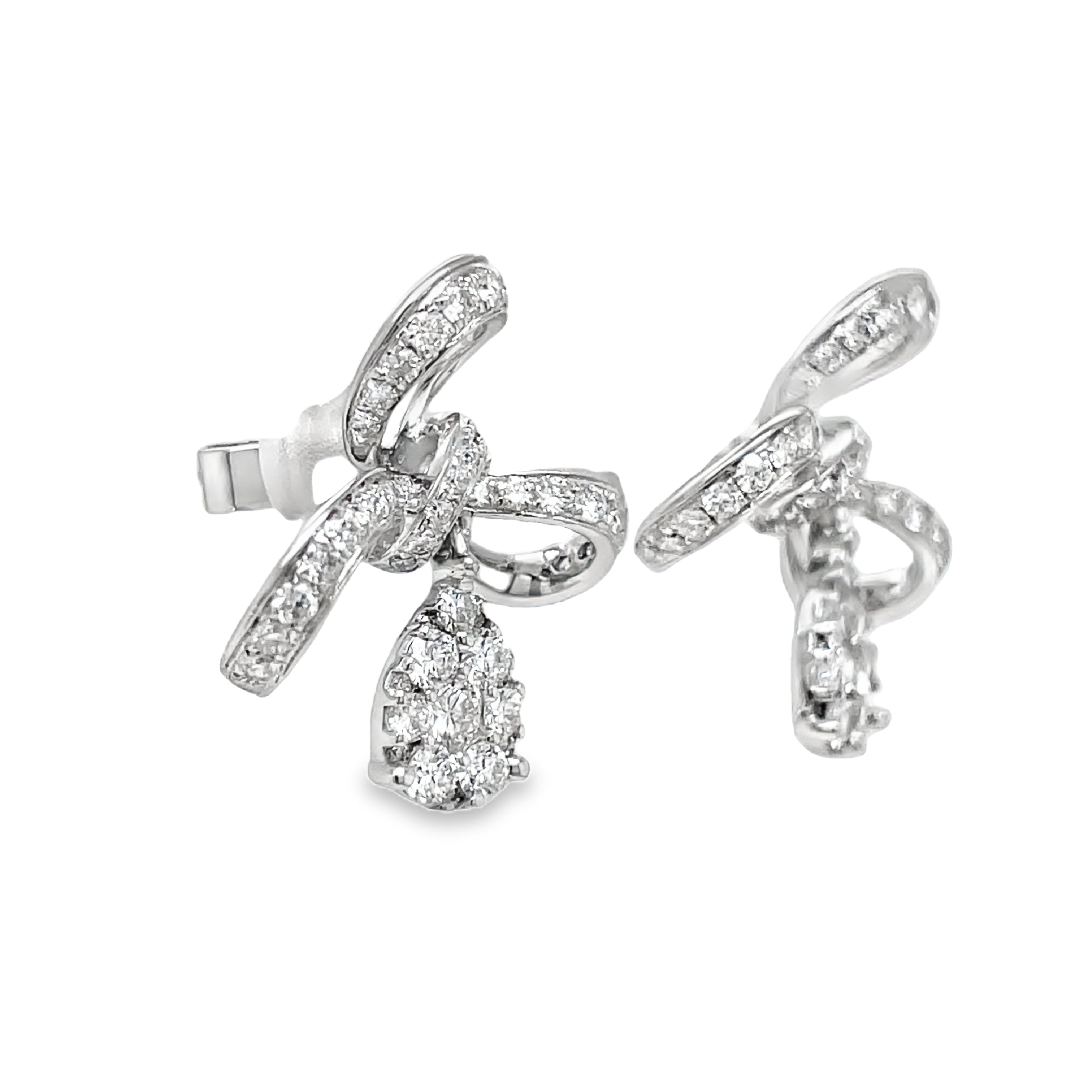 Indulge in pure elegance with our 18K Stunning Diamond Bow Drop Earrings. Crafted from 18k white gold, these earrings feature a delicate bow design adorned with sparkling round diamonds totaling 1.01 ct. Perfect for adding a touch of sophistication and luxury to any outfit.