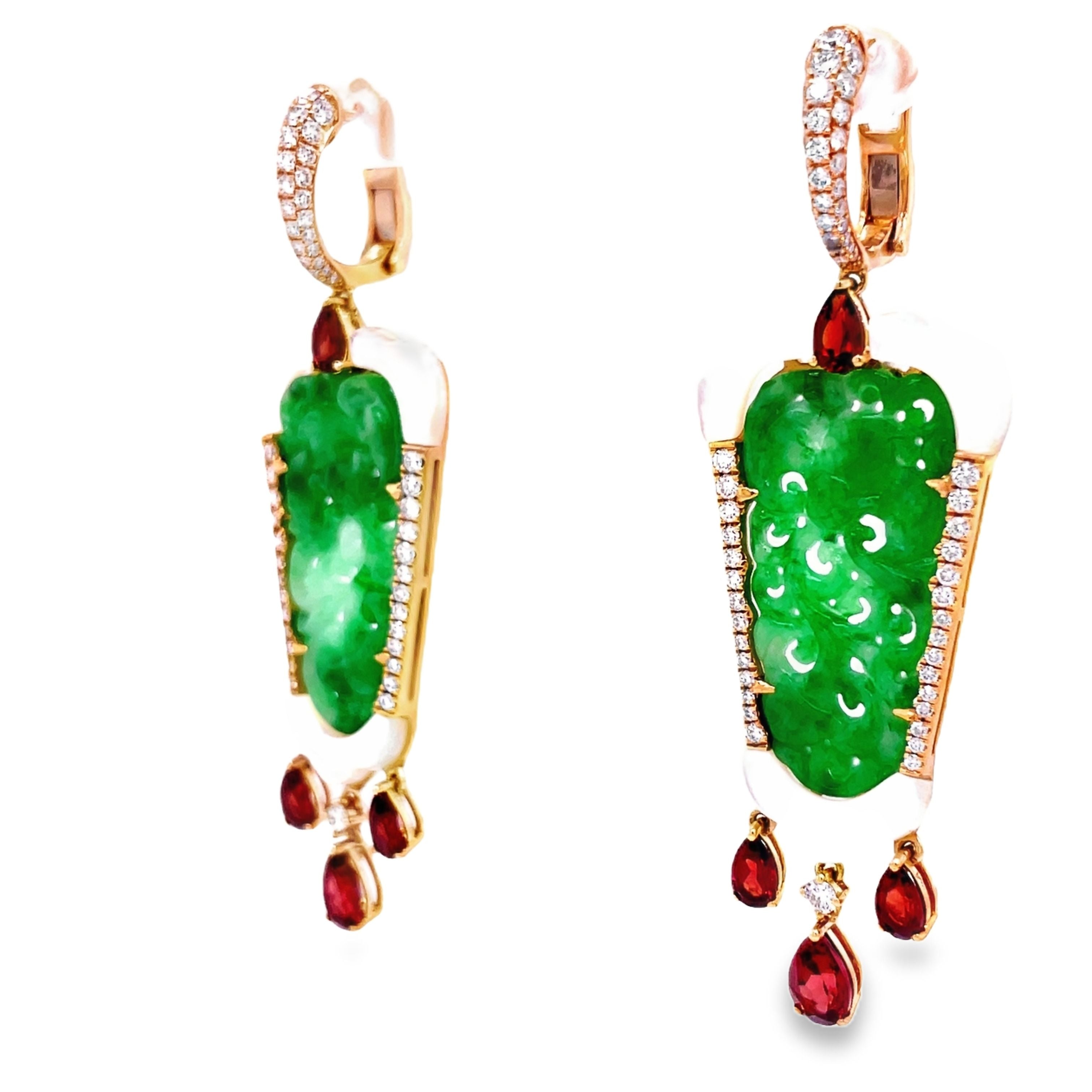 Elevate your style with these stunning green jade earrings hand carved with mother pearl and dazzling round diamonds. The dangling pear shape garnets add a touch of elegance to this 18k yellow gold design. With a secure huggie system, these earrings are 2.5" long. Own a piece of art that will make you stand out.