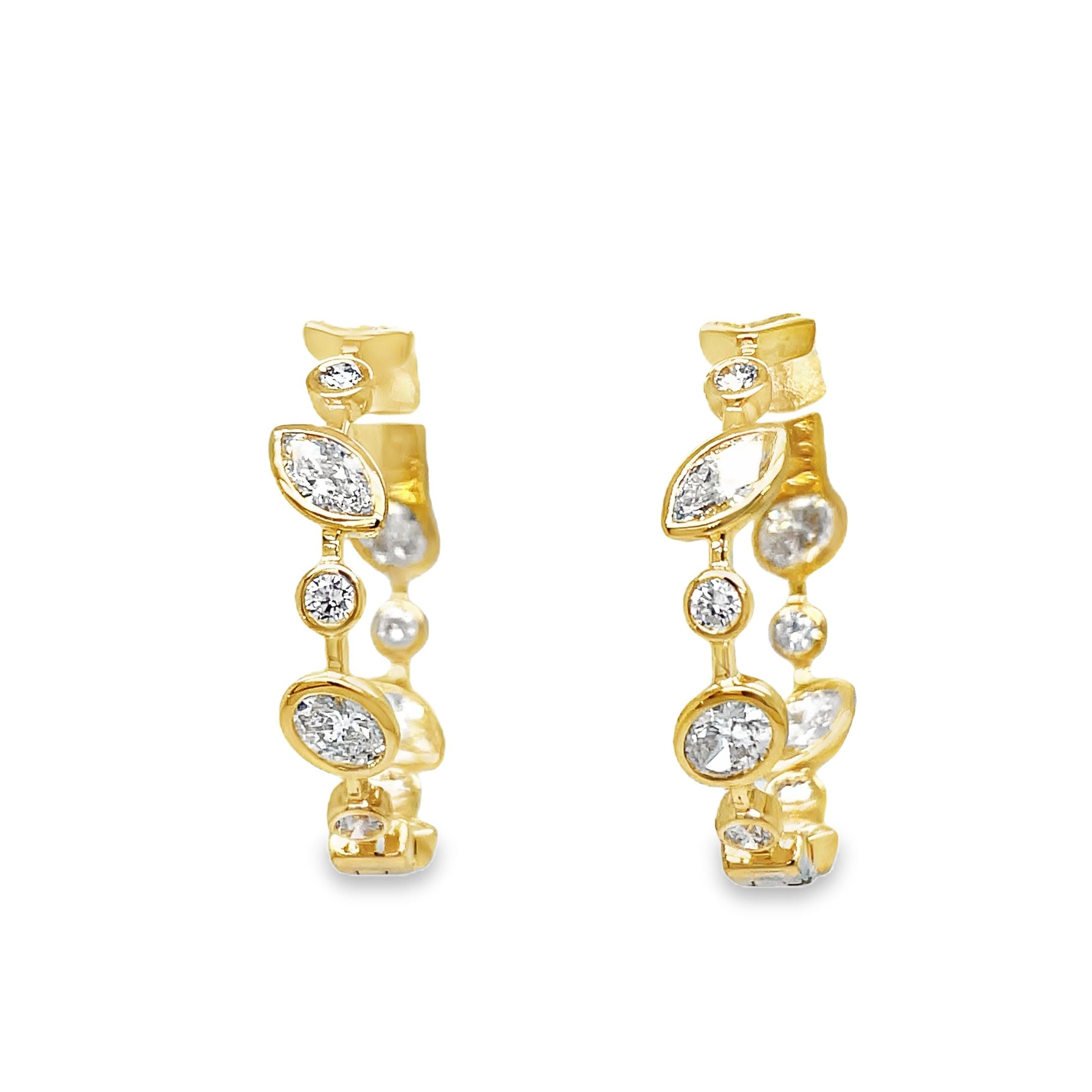 Upgrade your jewelry collection with our exclusive 18K Yellow Gold Mix Cut Bezel Set Diamond Hoop Earrings. Handcrafted with 2.14 carats of emerald, marquise, baguette, and round cut diamonds, these earrings radiate sophistication. The secure clasp system ensures durability, while the inside out diamonds add a subtle yet luxurious touch. Elevate any outfit with these elegant and timeless earrings.