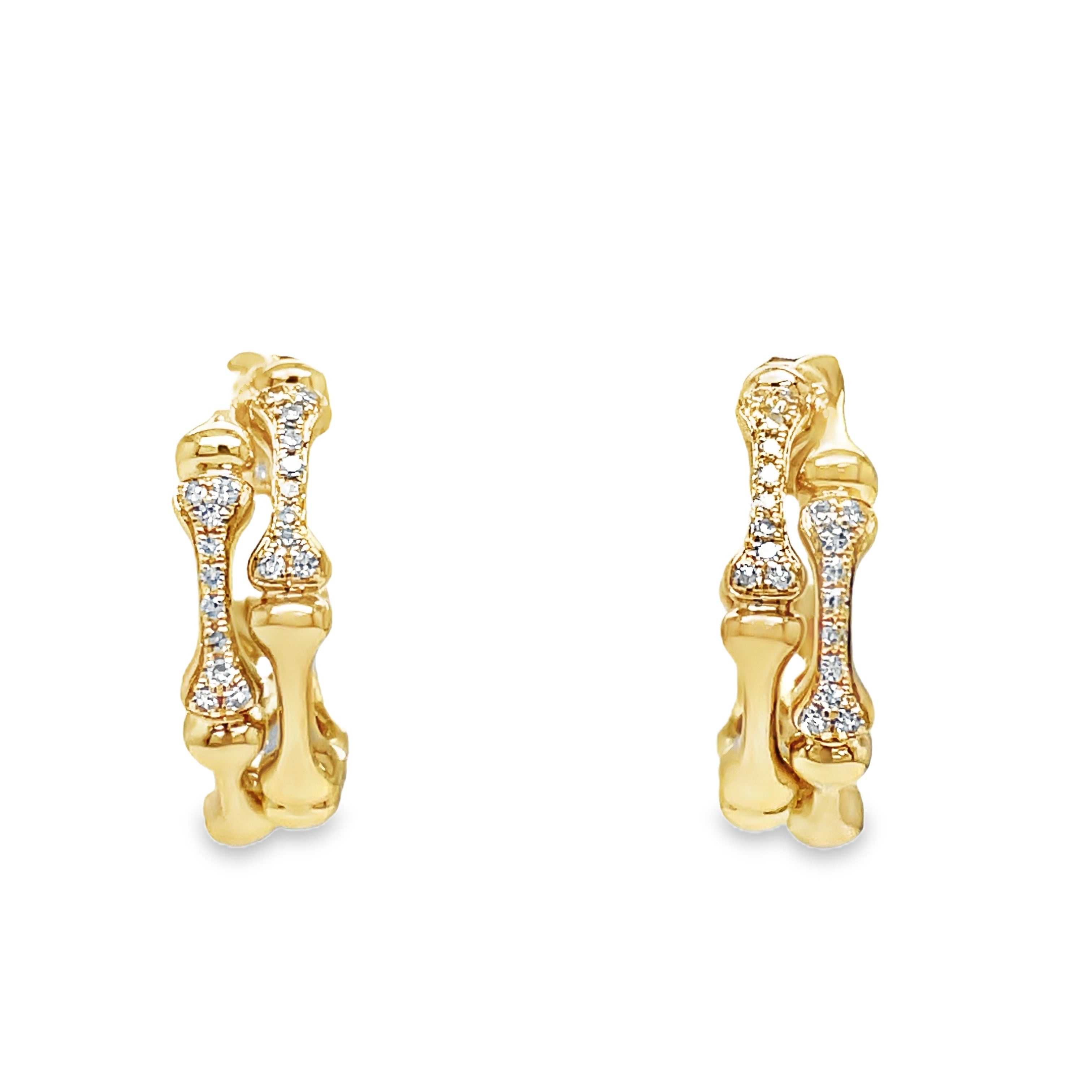 Indulge in luxury with our Diamond Bamboo Style Hoop Earrings. Crafted from 14k yellow gold, the bamboo style exudes elegance and the secure friction backs provide added peace of mind. Adorned with sparkling round diamonds, these earrings will elevate any outfit with their 0.09 cts of brilliance.