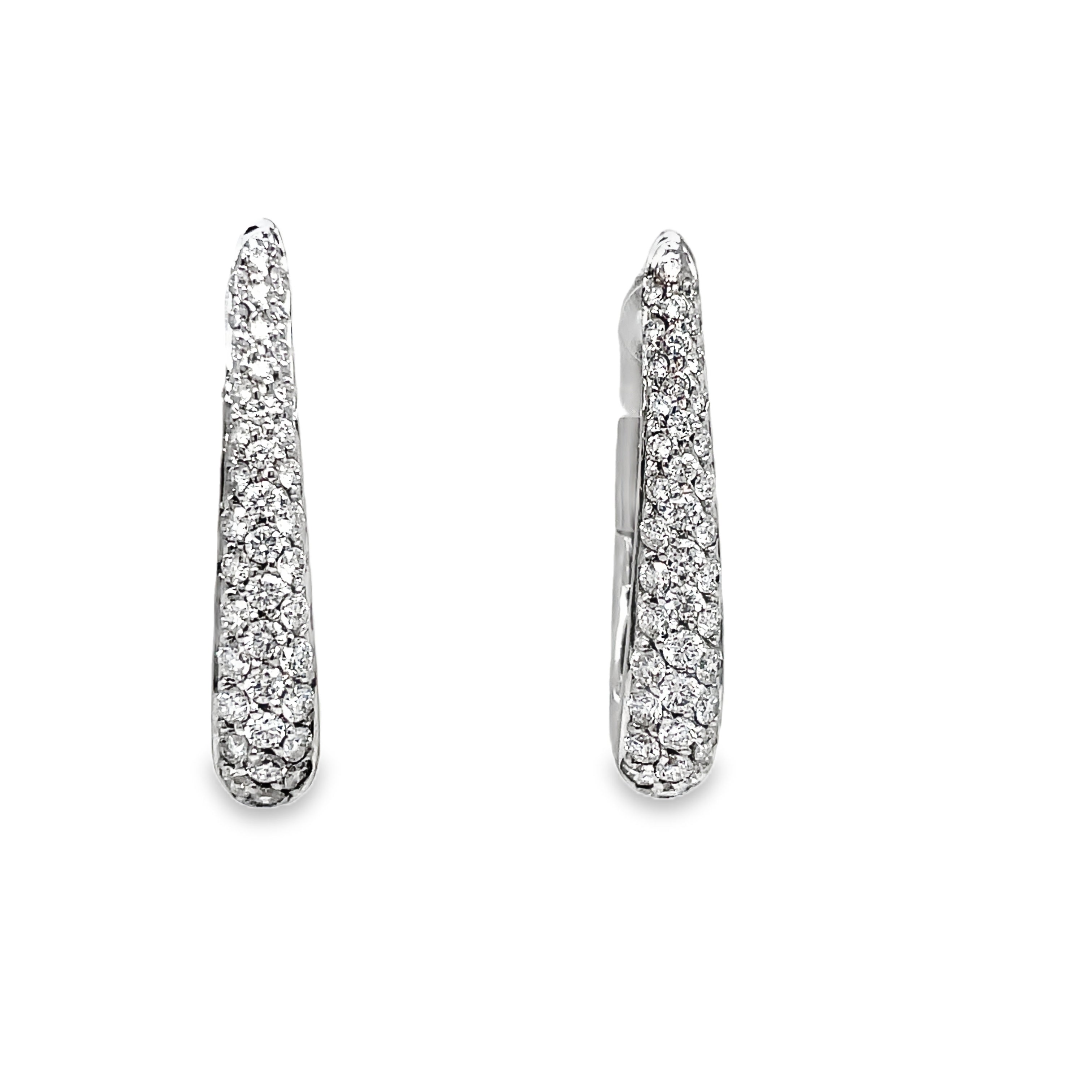 Accent your look with these exquisite Oval Shape Diamond Pave Hoop Earrings. Crafted from 18k white gold and adorned with 1.07 cts of diamond pave, these Italian-made earrings are both elegant and secure with a 1" long length and secure latch system. Elevate your style with luxury.