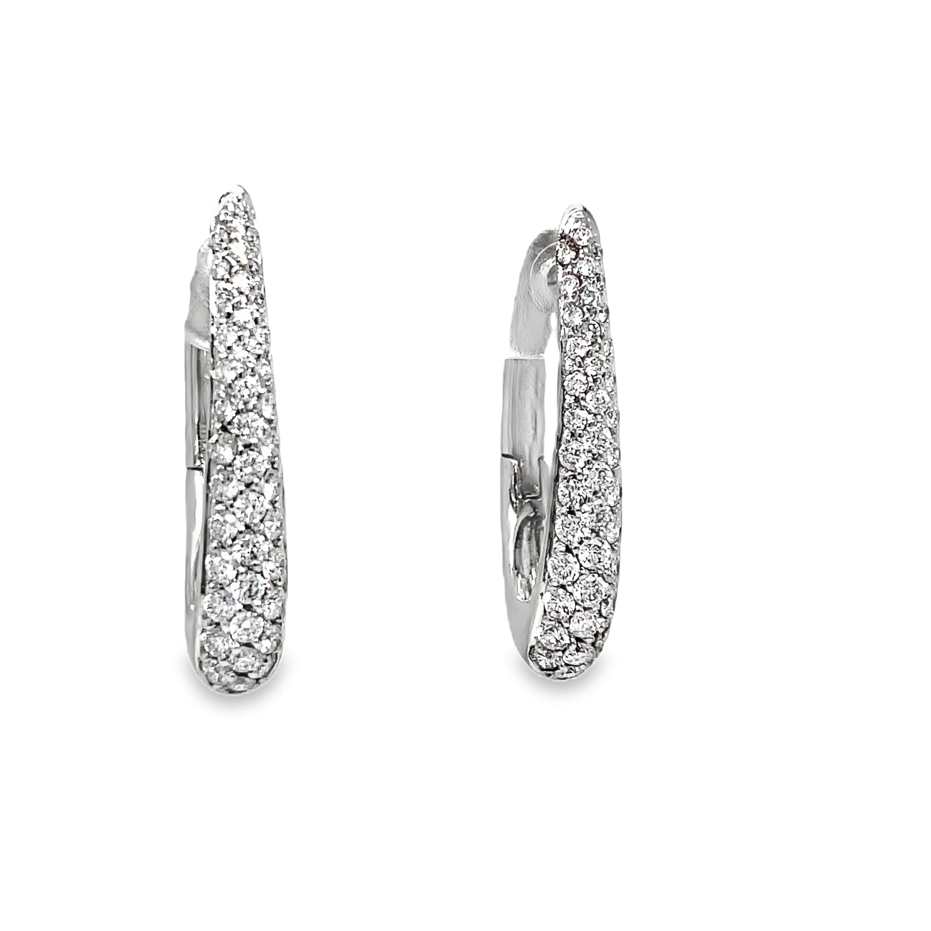 Accent your look with these exquisite Oval Shape Diamond Pave Hoop Earrings. Crafted from 18k white gold and adorned with 1.07 cts of diamond pave, these Italian-made earrings are both elegant and secure with a 1" long length and secure latch system. Elevate your style with luxury.