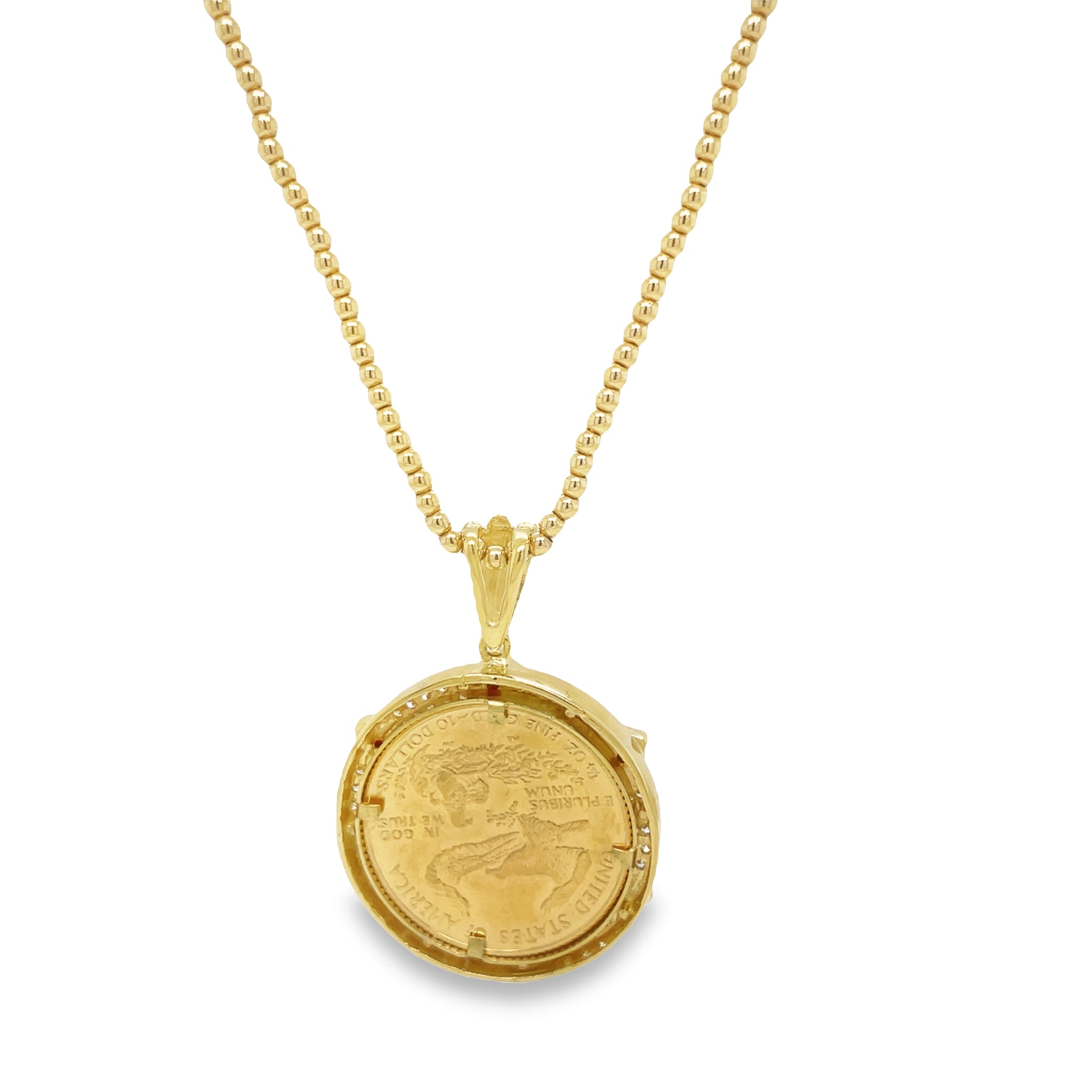This stunning necklace features an original 1/4 oz American Eagle coin encased in an impressive bezel frame made up of 1.00 cts round diamonds and 6 rubies. A strong bail hold the bezel in place, making it a secure and beautiful addition to any jewelry collection. An 18" bead chain is available for an additional cost ($999 -441-220)