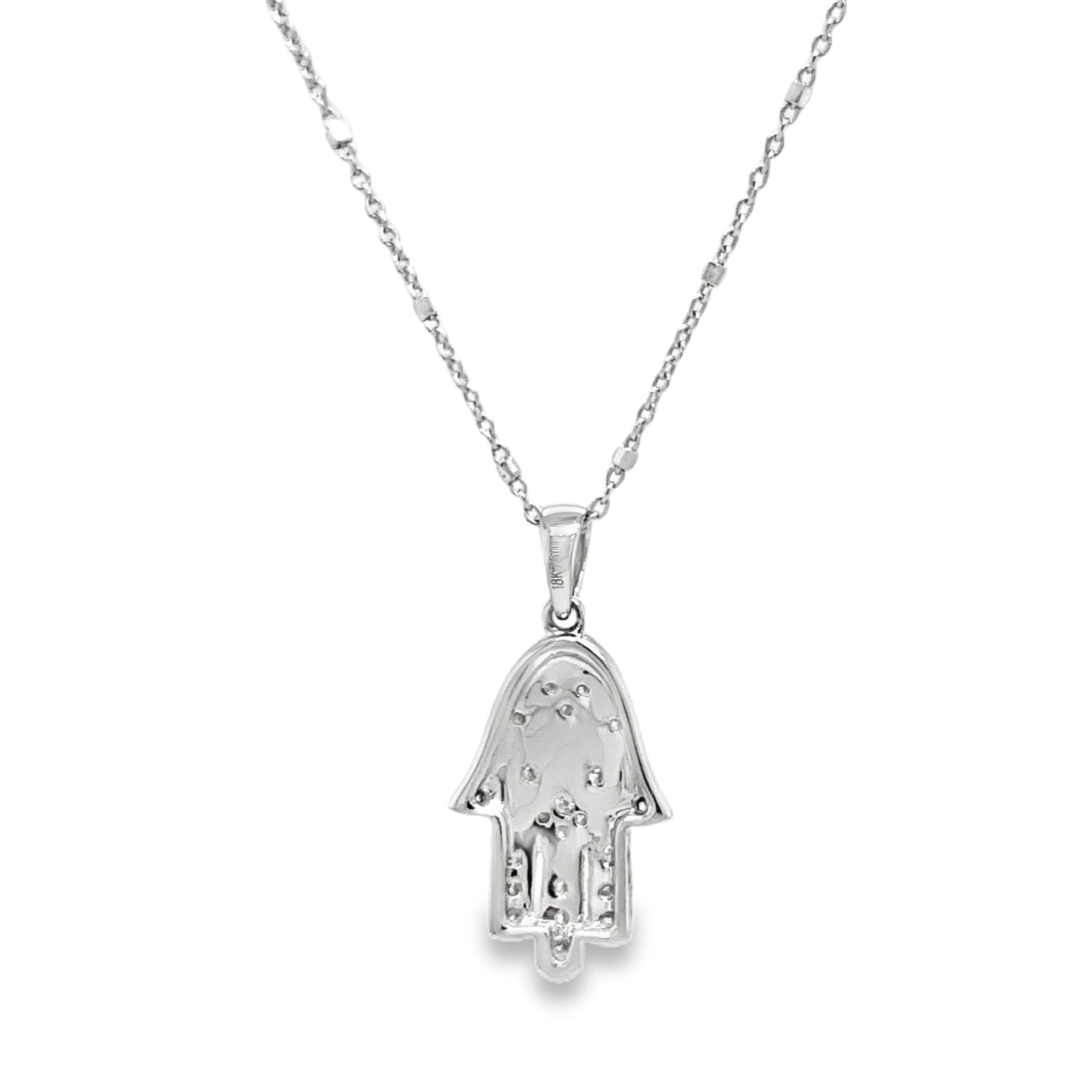 Adorn your neck with this dainty, yet classy diamond pendant necklace! Emblazoned with 0.20 carats of shimmering round diamonds set in 18k white gold, this piece features an expertly crafted hamsa with two sizeable loops and a small round diamond on the side. The lobster clasp ensures it stays securely in place on your neck at 16" long. Stylish and secure!

Italian Chain optional $350.00