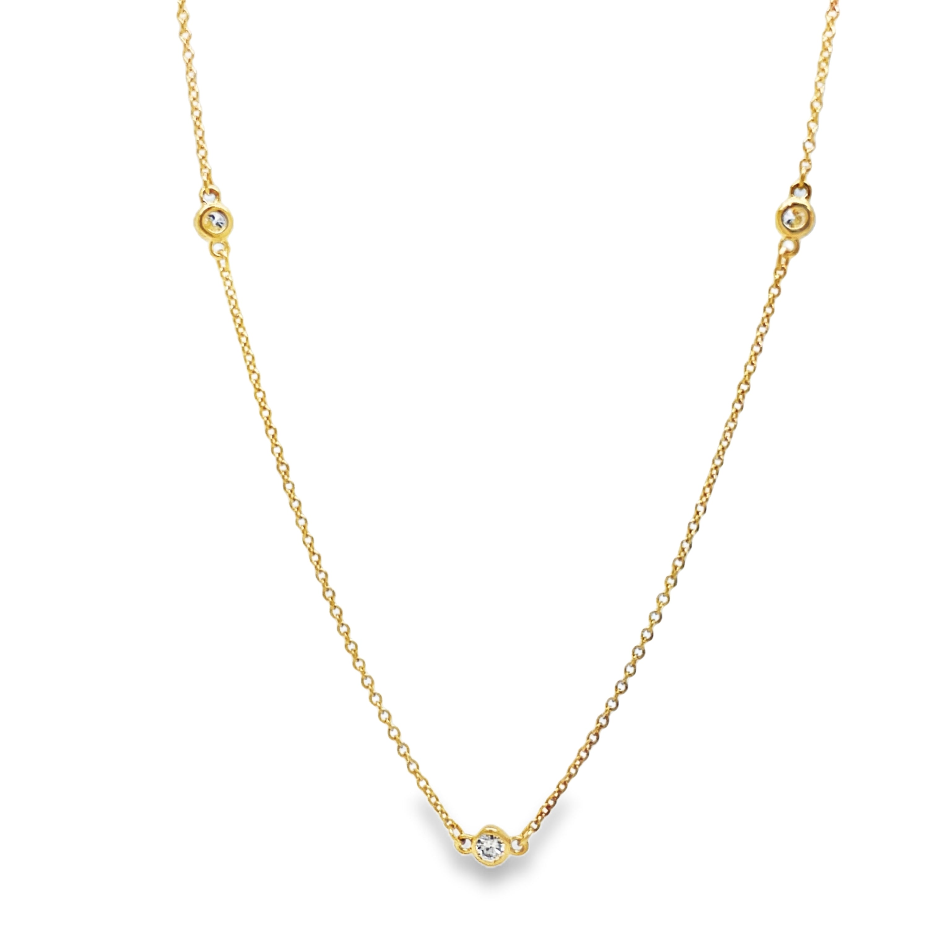 ndulge in the timeless elegance of our Diamond by the Yard Necklace. Adorned with a 5 brilliant 0.25 carat round diamond total securely bezel set in 14k yellow gold, this necklace exudes luxury and sophistication. The 18" chain is finished with a secure lobster catch, making it the perfect addition to any outfit. Elevate your style with this stunning piece today!