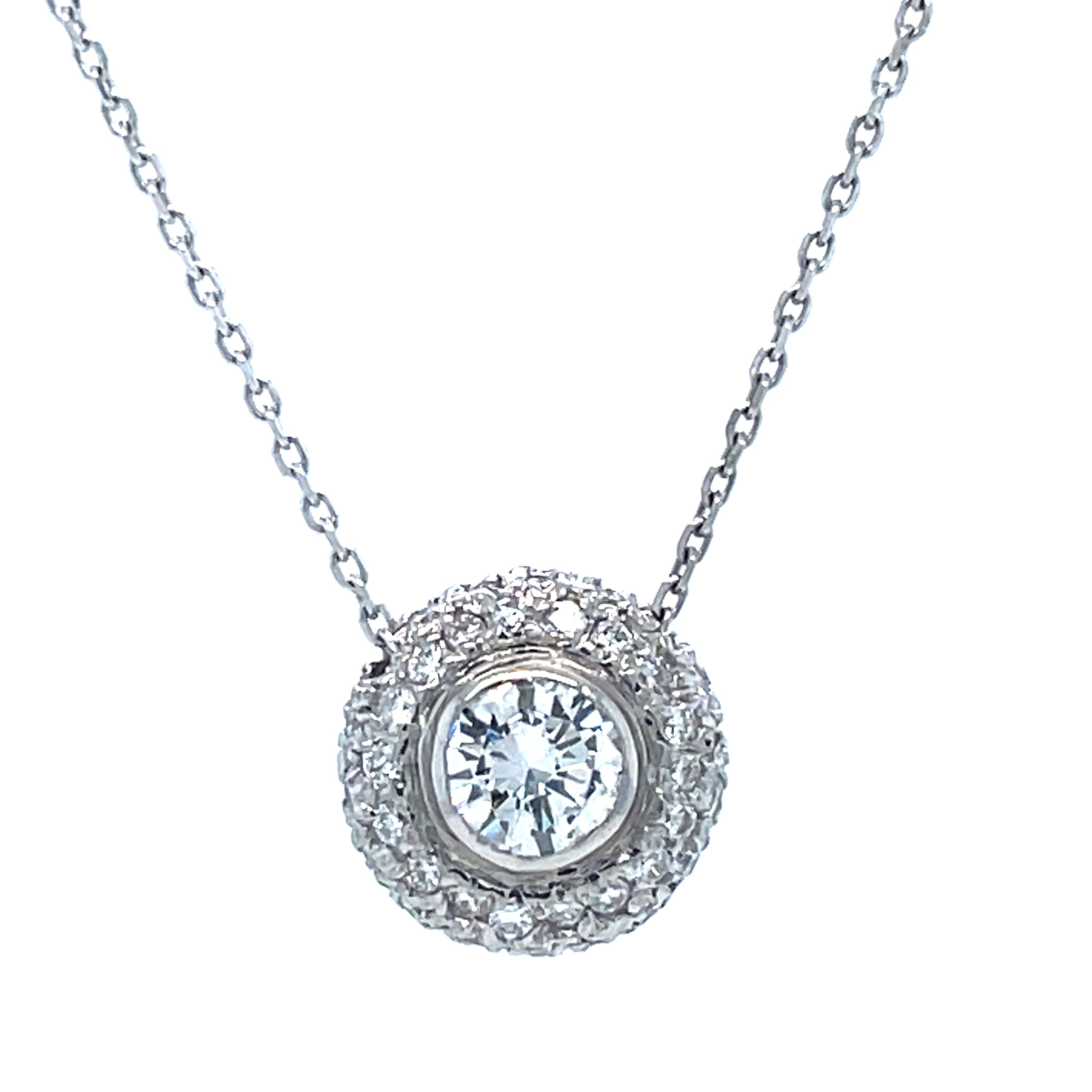 This luxurious diamond pendant necklace is crafted for brilliance and lasting beauty. It features a sparkling round 0.71 ct diamond solitaire at the center, surrounded by 0.50 cts of diamond pave setting. Set in 14k white gold, it also includes an 18" chain with a sizing loop at 16".