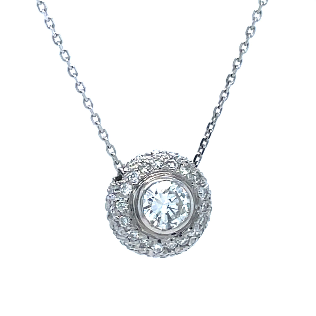 This luxurious diamond pendant necklace is crafted for brilliance and lasting beauty. It features a sparkling round 0.71 ct diamond solitaire at the center, surrounded by 0.50 cts of diamond pave setting. Set in 14k white gold, it also includes an 18" chain with a sizing loop at 16".