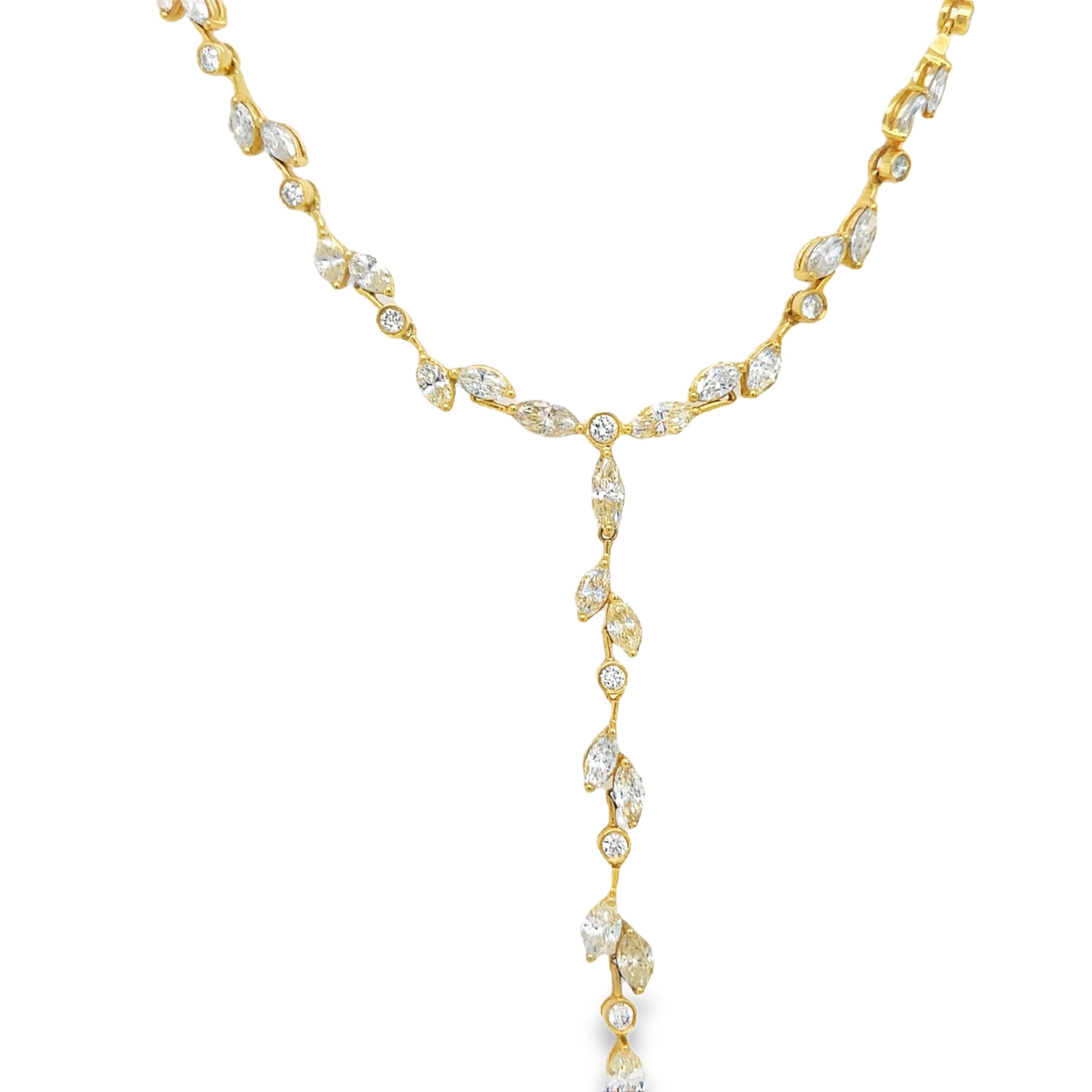 Indulge in the luxury of our Stunning Yellow Diamond Leaf Necklace. Handcrafted with 18k yellow and white gold, this exquisite necklace features 112 pear shape fancy yellow diamonds totaling 23.26 carats and 64 round white diamonds totaling 2.10 carats. With a secure figure 8 clasp, it radiates elegance and safety. At 17" in length, it's a true standout piece.