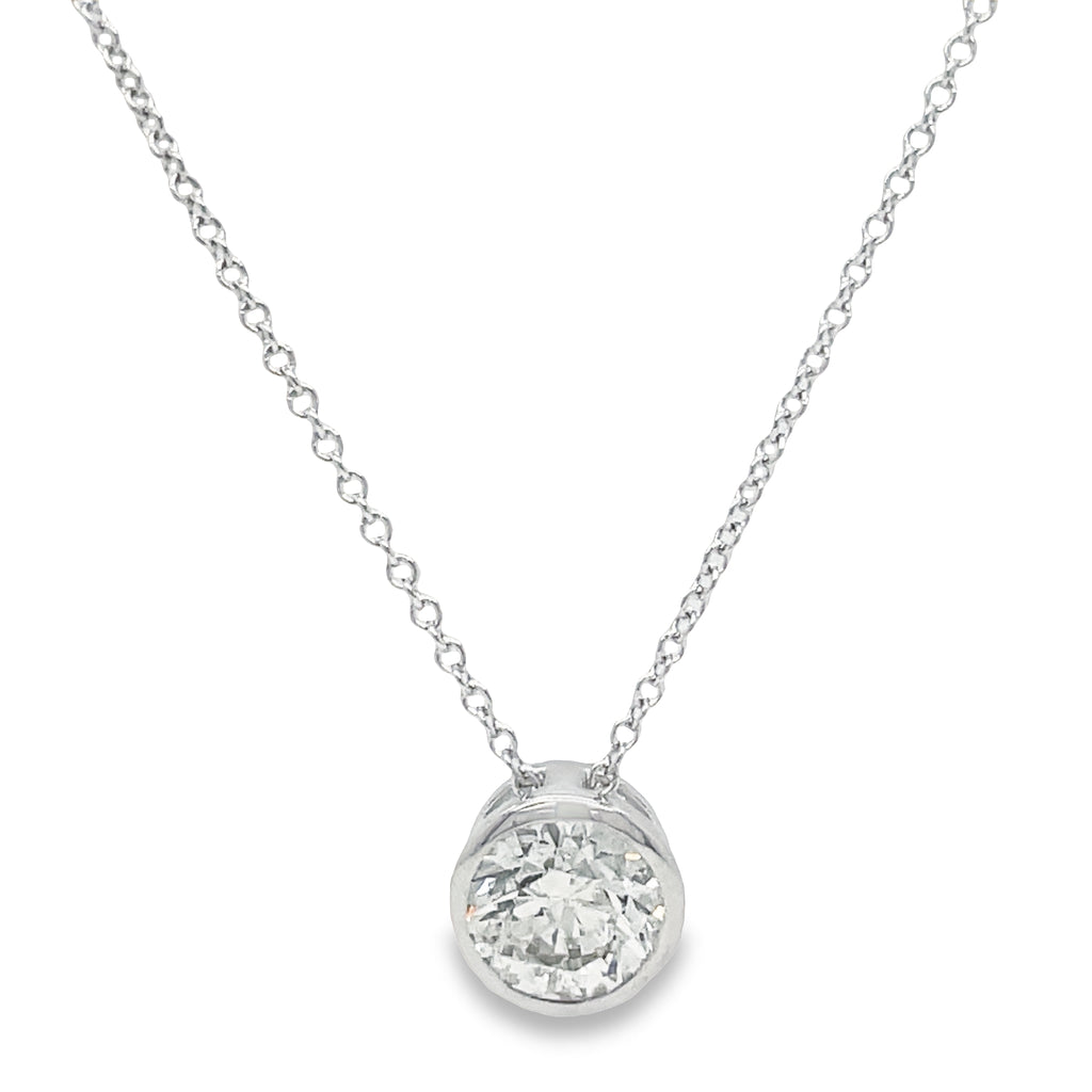 A timeless classic, this Diamond Solitaire Pendant Necklace radiates with dazzling brilliance. The 1.06 ct F/G color, SI1 clarity diamond is set in a 14k white gold bezel and hangs on a 16" long chain. It's a stunning statement piece that will make a lasting impression.