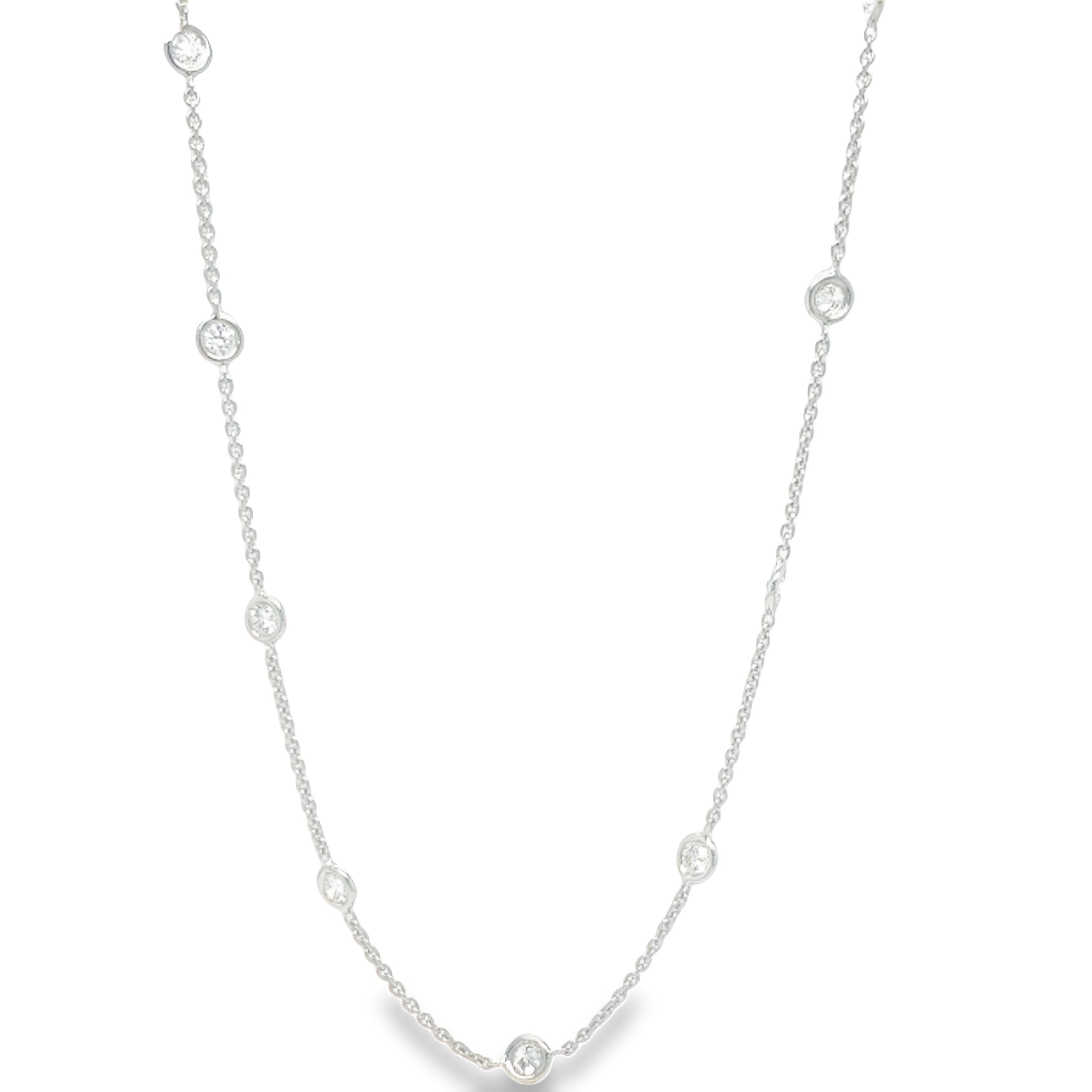 Elevate your jewelry collection with our Diamond by the Yard Necklace. Featuring 18 sparkling round diamonds totaling 1.50 cts, each bezel set for maximum brilliance. The secure lobster catch ensures this 18" necklace stays in place. A luxurious 18k white gold chain enhances the overall elegance