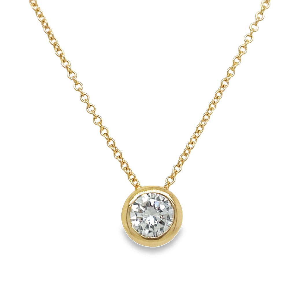 Indulge in luxury with our Round Diamond Solitaire Pendant Necklace. Crafted from 14k yellow gold, this necklace showcases a stunning round diamond weighing 0.44 cts. With a color grade of F/G and clarity of SI1, this piece radiates elegance and sophistication. The 18' length adds versatility, making it perfect for any occasion. Elevate your style with this exquisite necklace.
