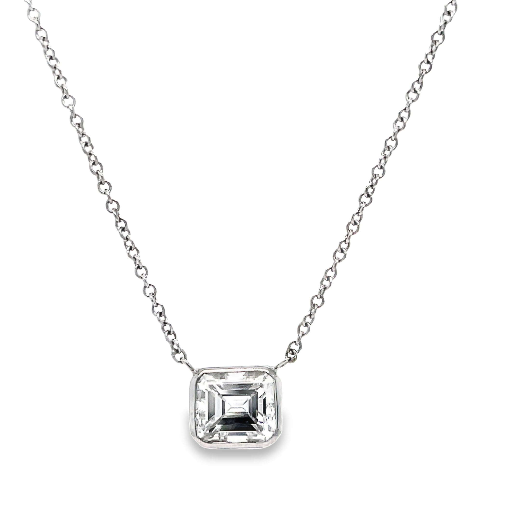 This exquisite pendant necklace features an emerald cut diamond weighing 1.19 carats with a color grade of E and clarity grade of VVS2, set in a 14k white gold pendant. The 18" long chain completes the elegant look. Enhance any outfit with this stunning piece of timeless jewelry.