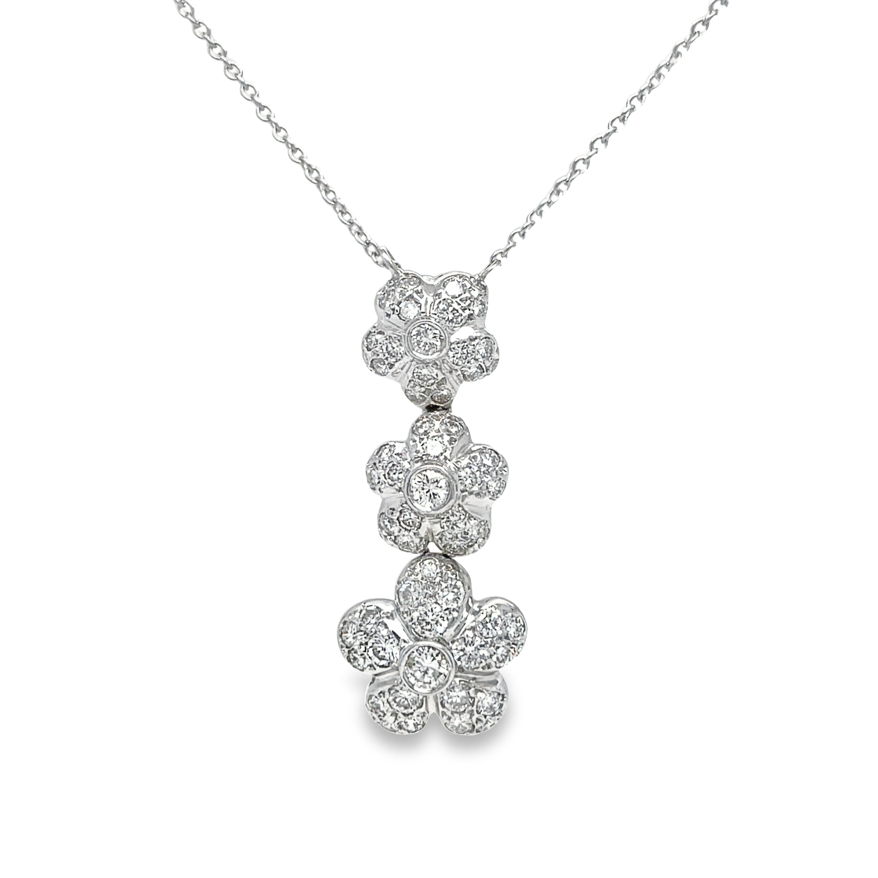 Indulge in luxury with our Three Diamond Drop Flower White Gold Necklace. Adorn yourself with elegance and sophistication with this 14 kt white gold necklace featuring three exquisite diamond flowers totaling 1.50 tw. Upgrade your style with this one-of-a-kind piece.