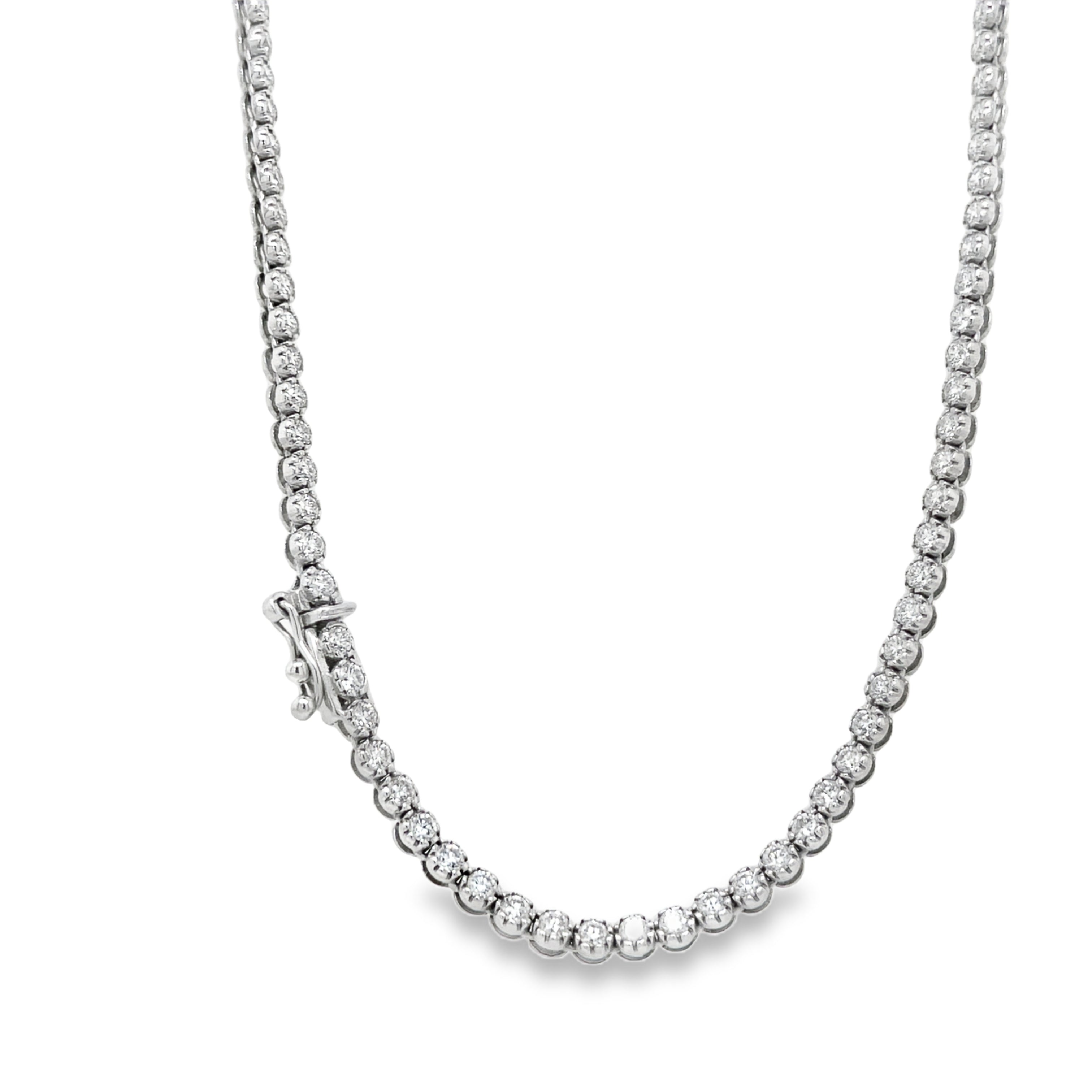 Elevate your look with our exquisite Diamond Tennis Necklace. Crafted in 18k white gold, this tennis line necklace boasts 8.00 cts of sparkling diamonds. The hidden clasp and figure 8 design provide a secure fit, while the E/F color and VS1 clarity ensure unparalleled beauty. Indulge in luxury.