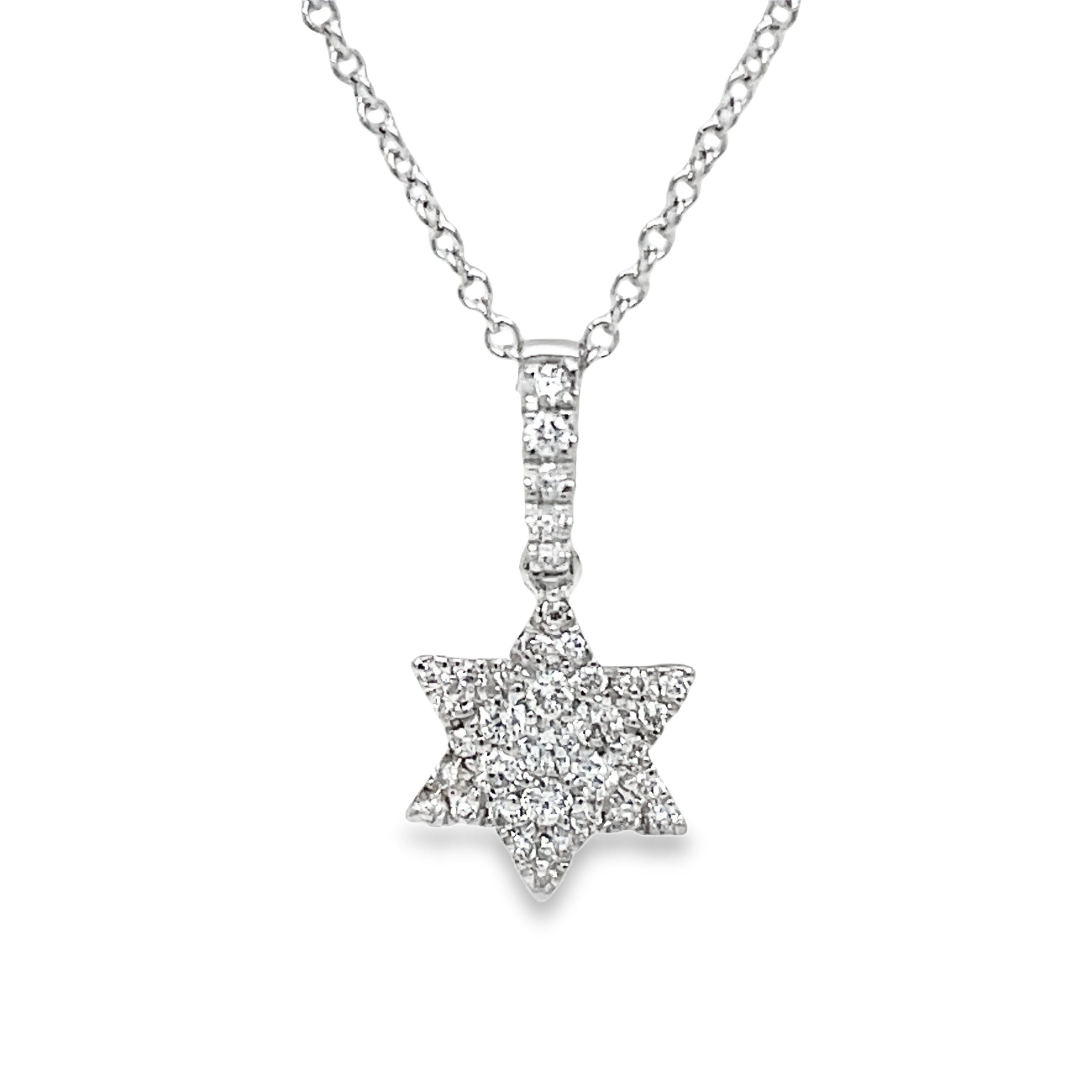 This exquisite pendant necklace 15.00 mm features a star of David inlaid with 18k white gold and adorned with dazzling round diamonds, enhancing its timeless symbol with a touch of elegance. The diamonds, totaling 0.14 cts, are of color E/F and clarity VS, adding a luxurious sparkle to this delicate piece in a 16" white gold chain.