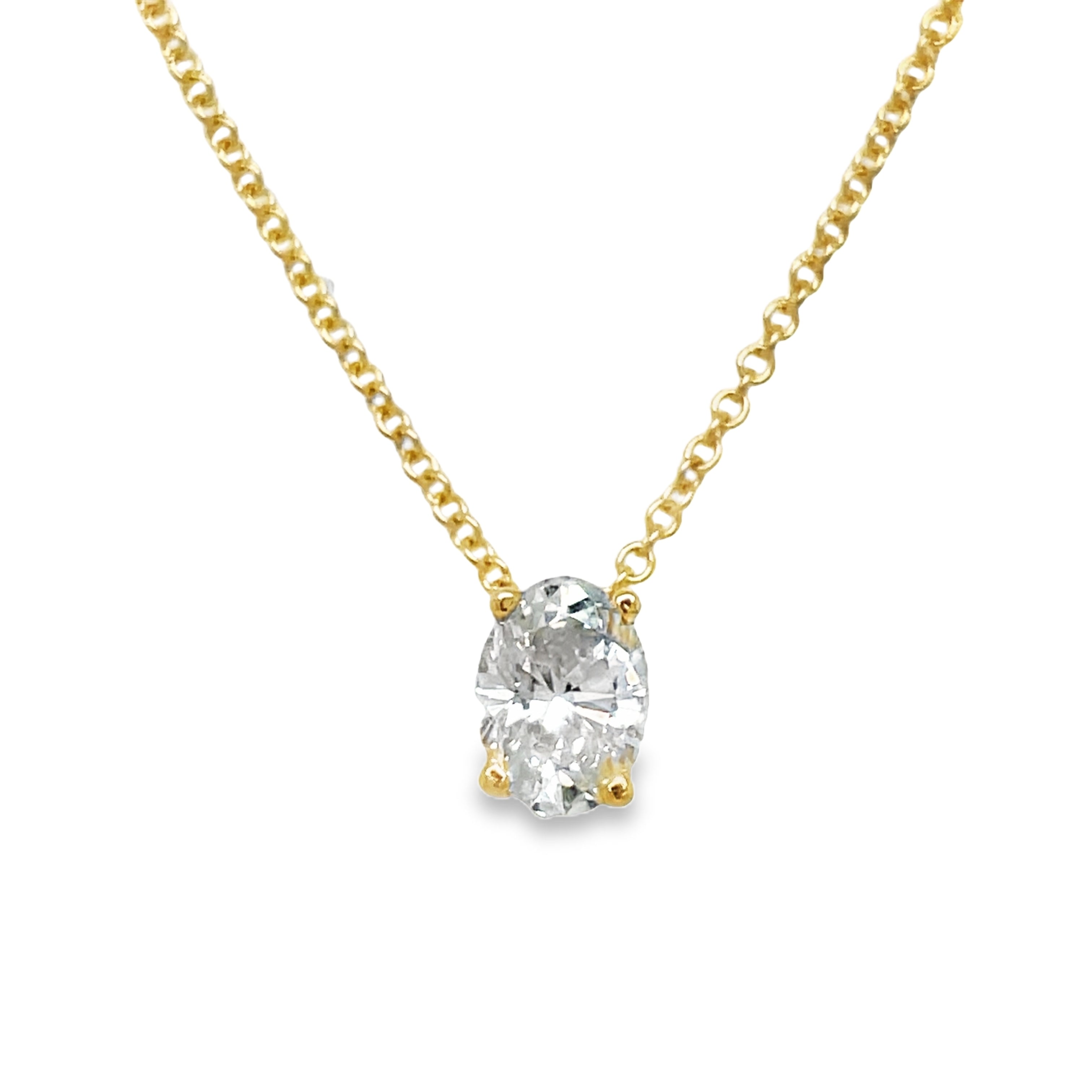 Indulge in understated luxury with our Oval Cut Diamond Solitaire Yellow Gold Necklace. The 1.20 carat oval cut diamond is elegantly set in a secure prong setting, suspended on a 16" yellow gold chain. Perfect for any occasion, this necklace exudes sophistication and grace.