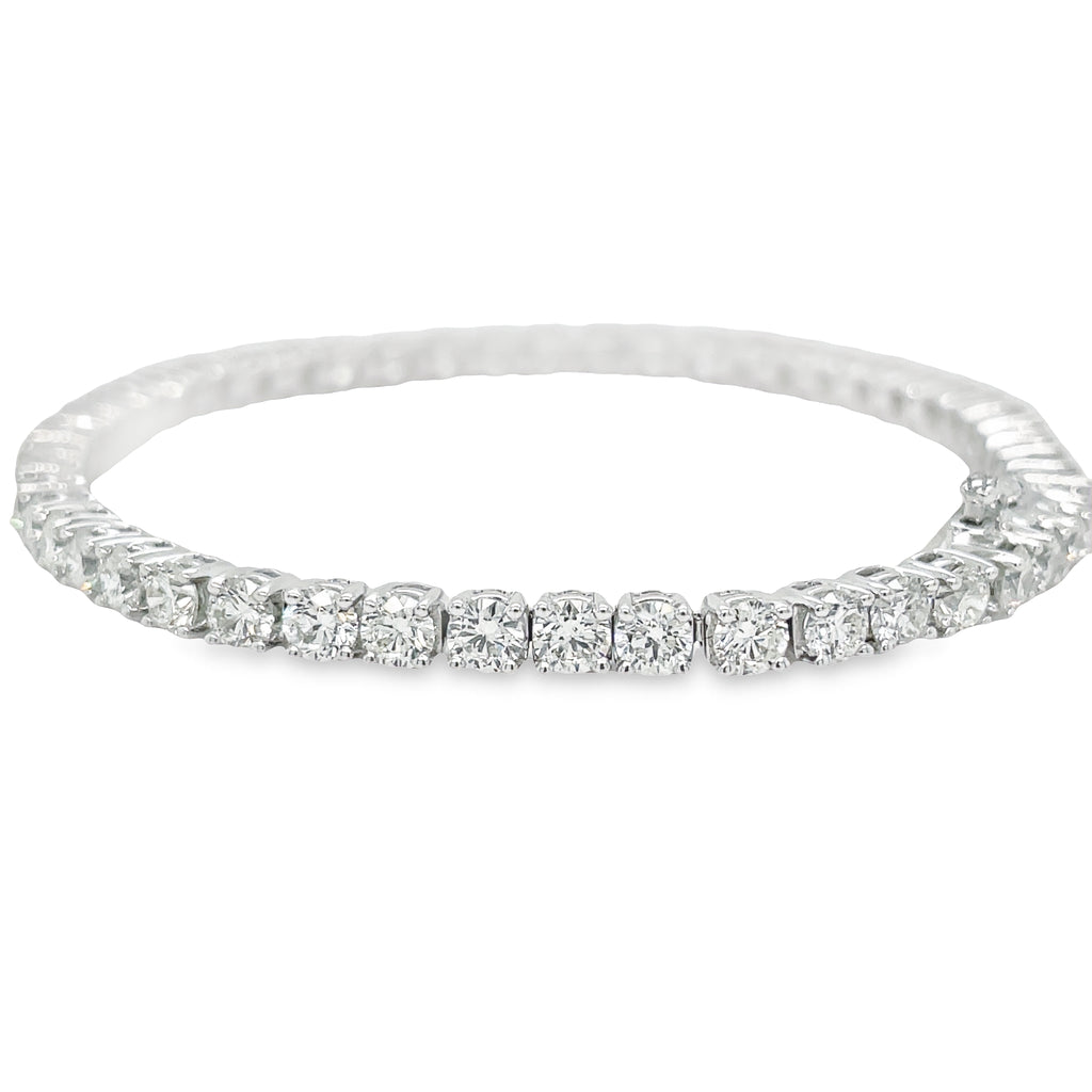 This Diamond Line Tennis Bracelet is crafted with 14k white gold and is encrusted with 7.75 carats of brilliant diamonds, color J and clarity VS1. The 7' length is secured with a hidden clasp for a subtle and elegant finish. Perfect for special occasions, this timeless piece will make a striking addition to any jewelry collection.