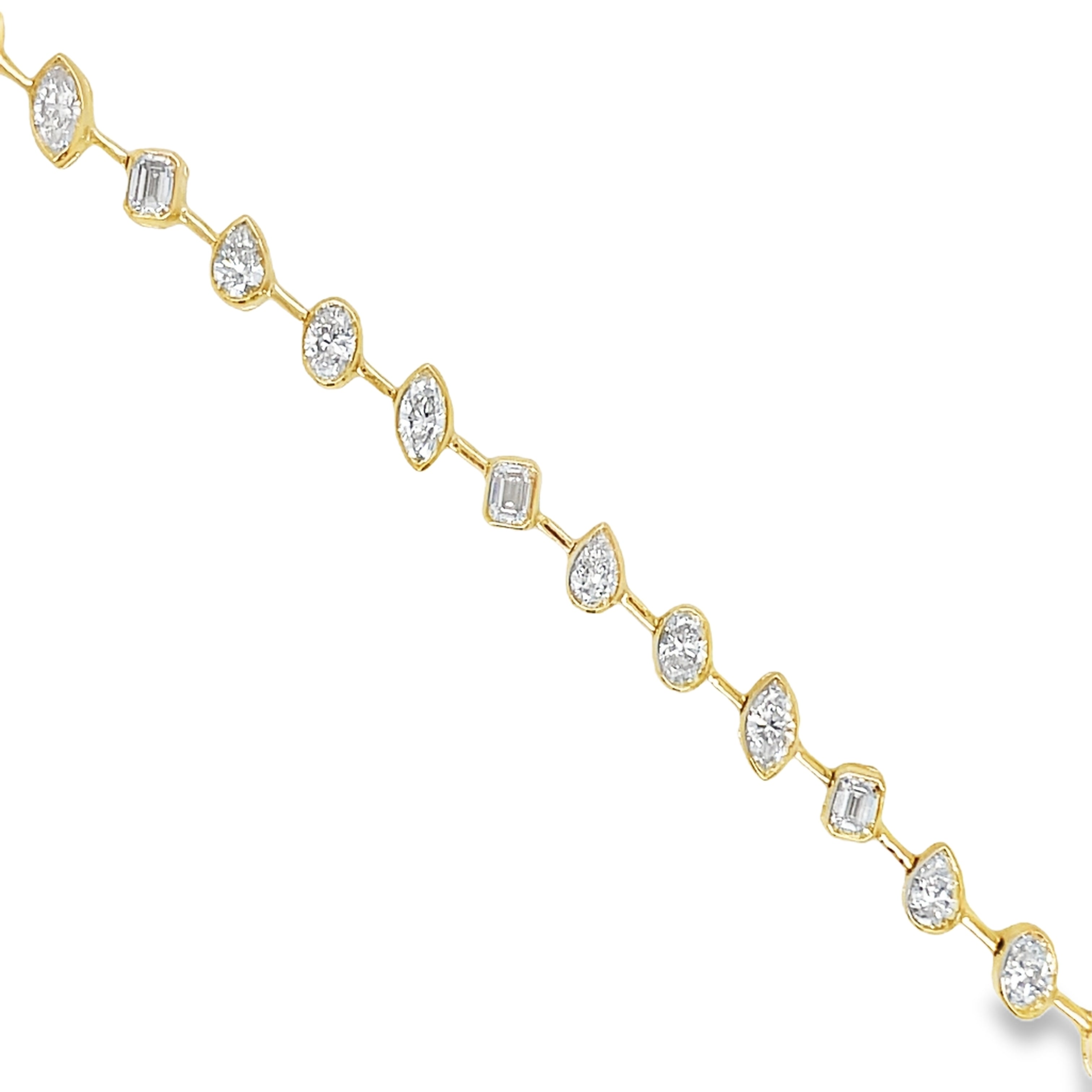 Indulge in luxury with our Mixed Fancy Cut Slant Diamond Bracelet. The unique and modern design features a mixed variety of fancy cut diamonds in pear, oval, emerald, and round shapes, all set in 18k yellow gold. With a dazzling F/G color and VS1 clarity, this bracelet is a true symbol of sophistication. Securely fastened with a clasp, it measures 7 inches in length. Elevate your style with this exquisite piece.