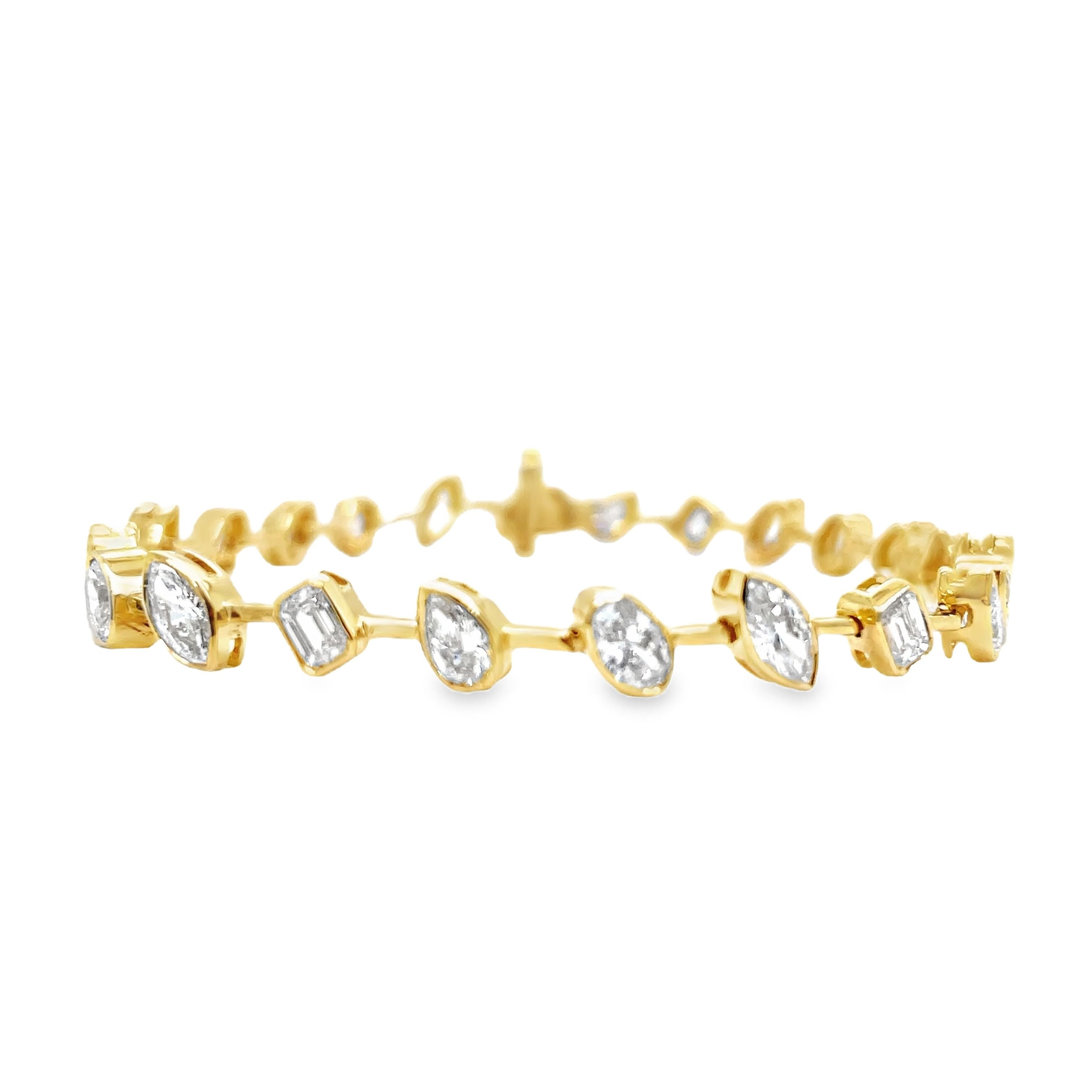 Indulge in luxury with our Mixed Fancy Cut Slant Diamond Bracelet. The unique and modern design features a mixed variety of fancy cut diamonds in pear, oval, emerald, and round shapes, all set in 18k yellow gold. With a dazzling F/G color and VS1 clarity, this bracelet is a true symbol of sophistication. Securely fastened with a clasp, it measures 7 inches in length. Elevate your style with this exquisite piece.