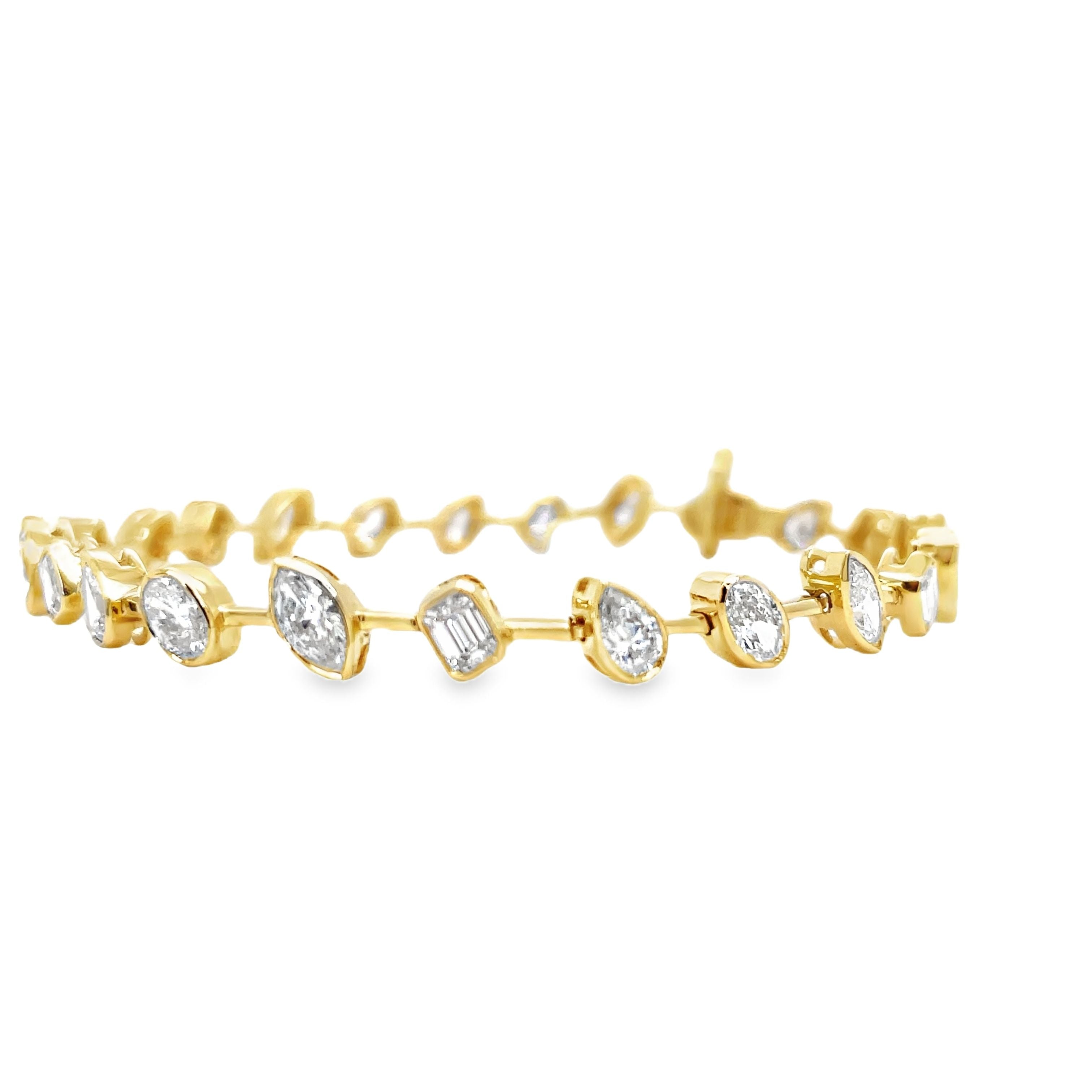 Indulge in luxury with our Mixed Fancy Cut Slant Diamond Bracelet. The unique and modern design features a mixed variety of fancy cut diamonds in pear, oval, emerald, and round shapes, all set in 18k yellow gold. With a dazzling F/G color and VS1 clarity, this bracelet is a true symbol of sophistication. Securely fastened with a clasp, it measures 7 inches in length. Elevate your style with this exquisite piece.