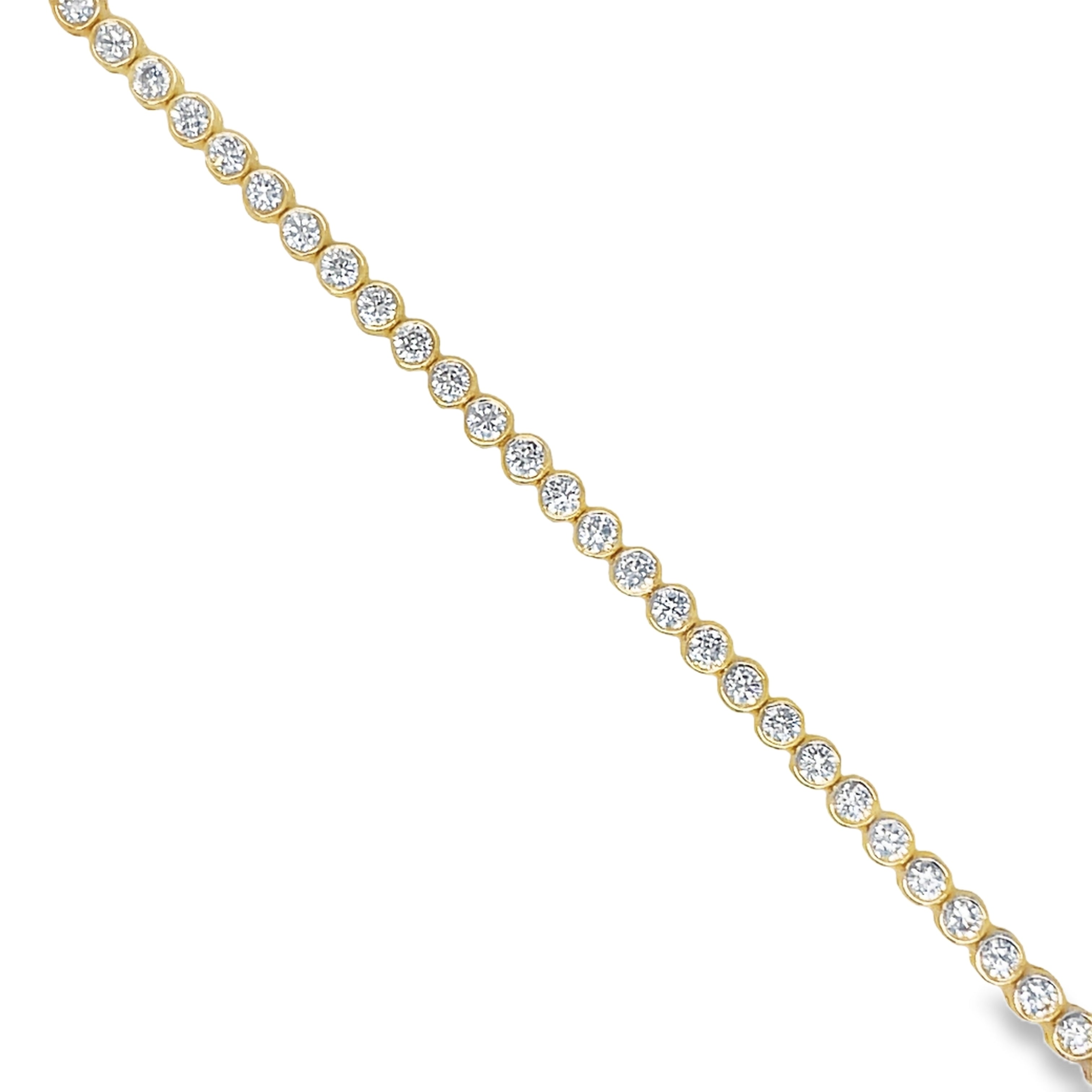 his luxurious 14k yellow gold bracelet features 2.92 carats of round diamonds, each expertly bezel-set for added sophistication. With a color rating of G/H and a clarity rating of SI1, this bracelet is truly a masterpiece. The double figure eight design adds a touch of elegance to this already exclusive piece. Elevate any outfit with this stunning bezel diamond tennis bracelet.