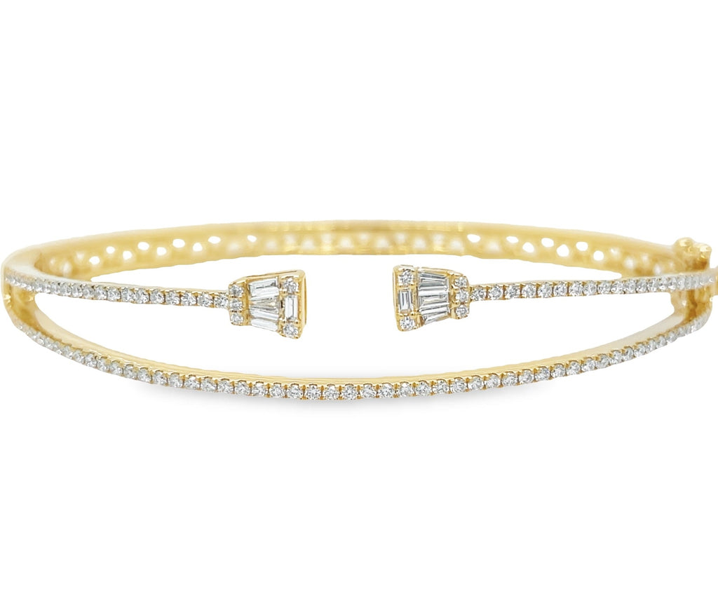 This 18k yellow gold cuff bangle is crafted with a double row of glittering diamonds. The round and baguette mixed cut diamonds offer an alluring sparkle and the secure clasp adds a reassuring safety lock to this stunning piece of jewelry. Look captivating in this lustrous diamond bangle!